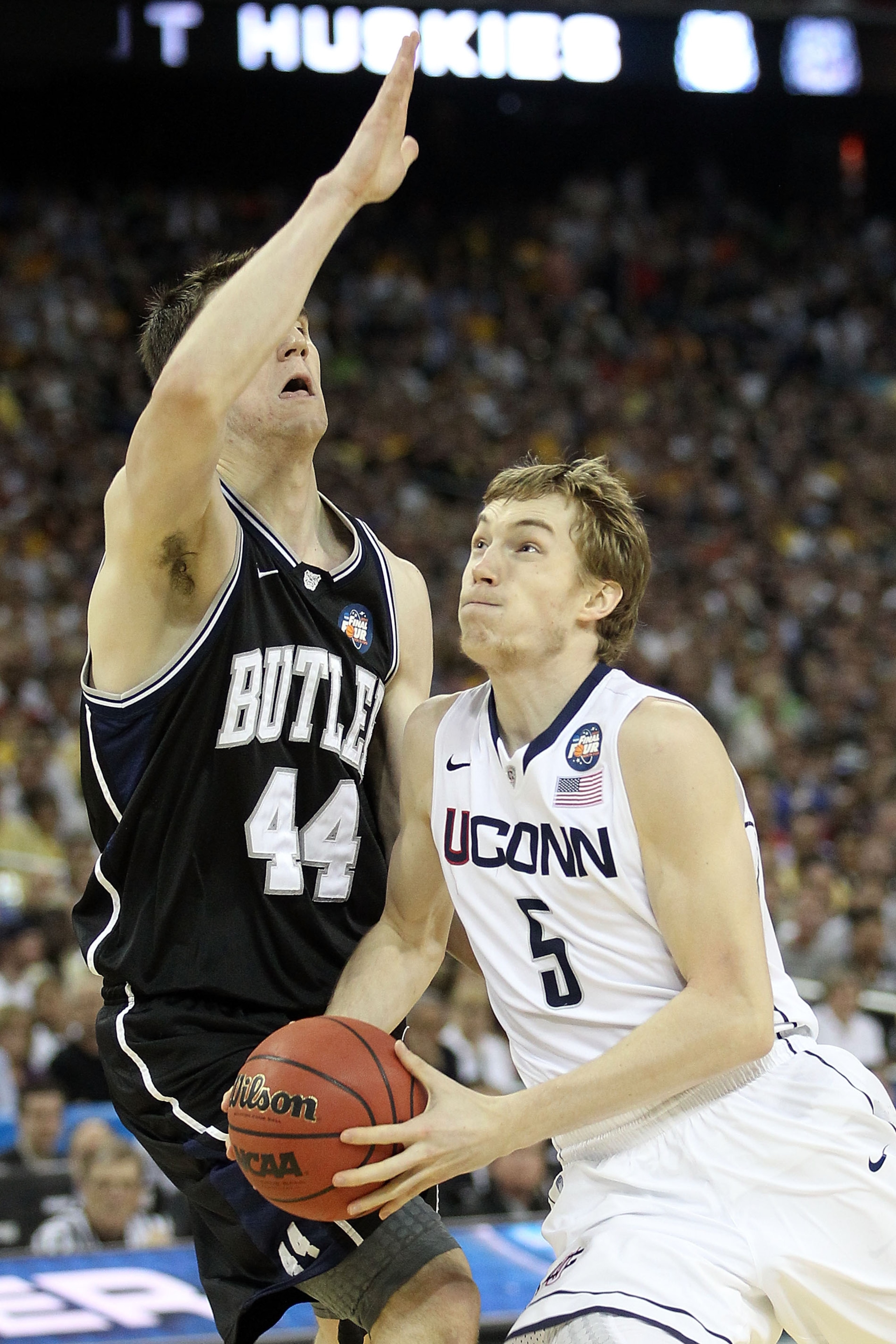 HOUSTON, TX - APRIL 04:  Niels Giffey #5 of the Connecticut Huskies goes to the basket against Andrew Smith #44 of the Butler Bulldogs during the National Championship Game of the 2011 NCAA Division I Men's Basketball Tournament at Reliant Stadium on Apri