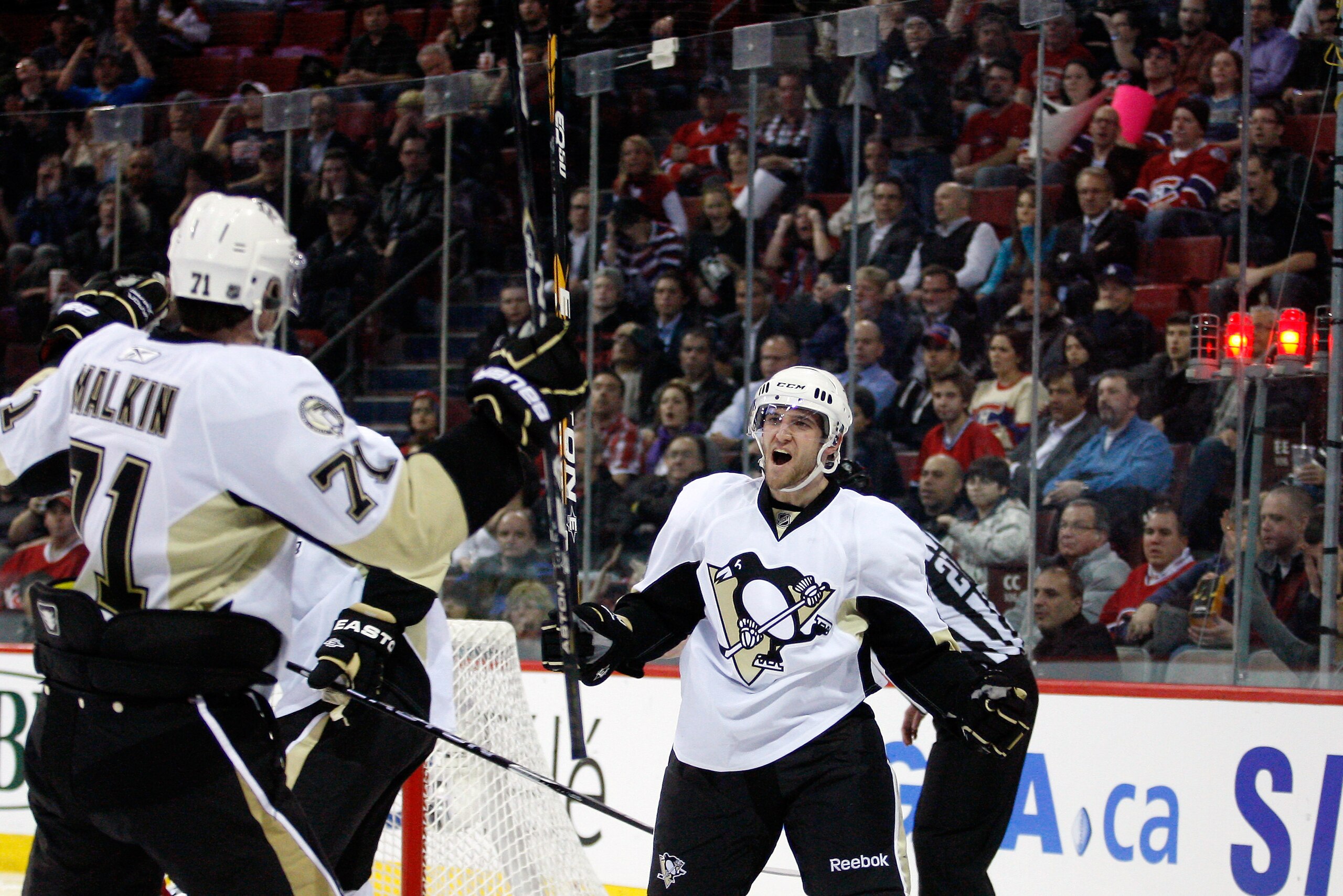 MONTREAL, CANADA - JANUARY 12:  Alex Goligoski #3 of the Pittsburgh Penguins celebrates his third period goal with team mate Evgeni Malkin #71 during the NHL game against the Montreal Canadiens at the Bell Centre on January 12, 2011 in Montreal, Quebec, C