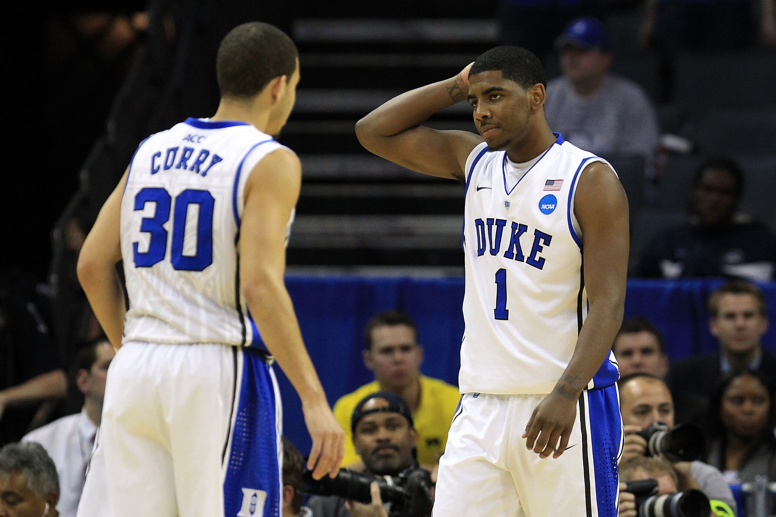 CHARLOTTE, NC - MARCH 20:  Kyrie Irving #1 looks over at teammate Seth Curry #30 of the Duke Blue Devils while taking on the Michigan Wolverines during the third round of the 2011 NCAA men's basketball tournament at Time Warner Cable Arena on March 20, 20