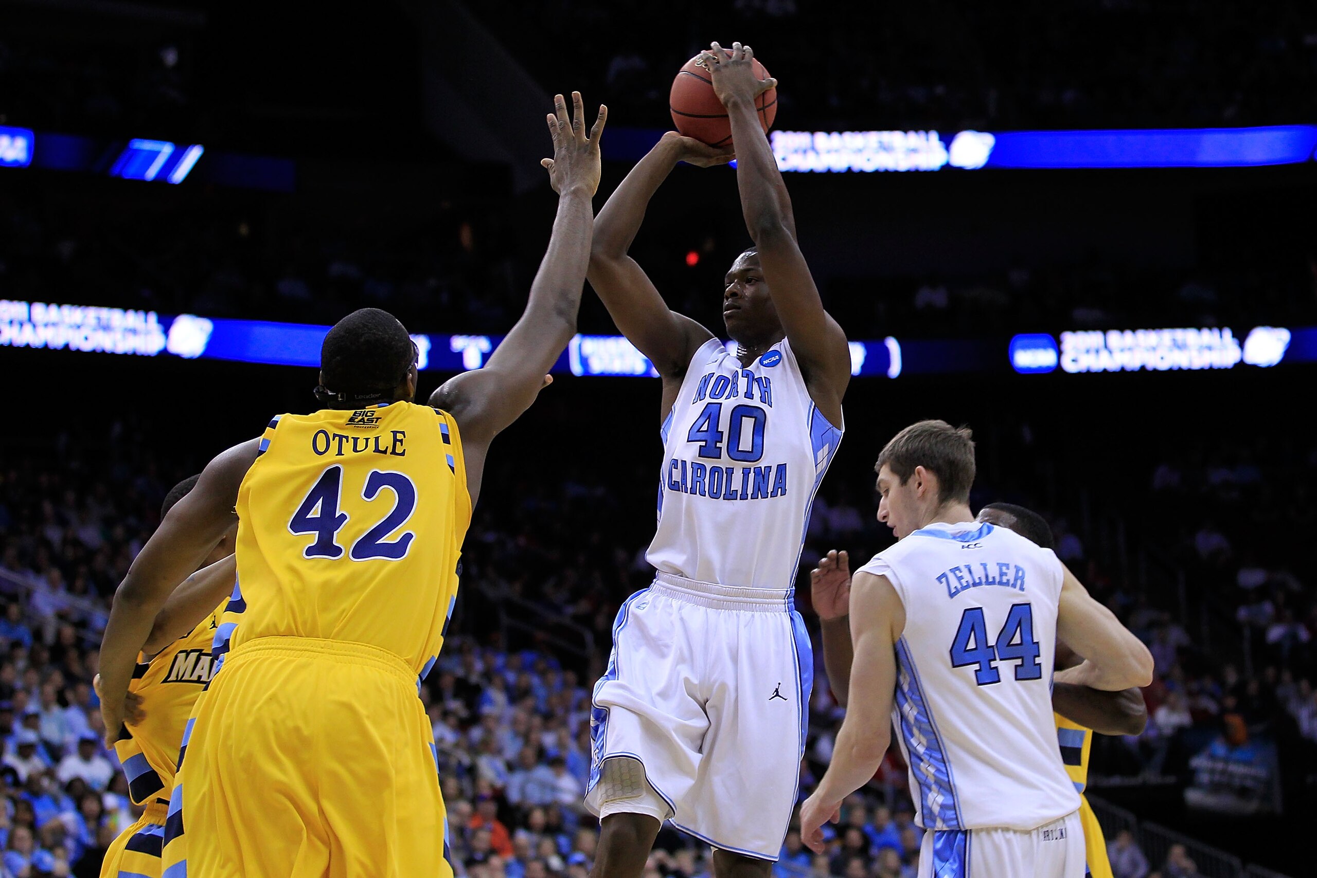 NEWARK, NJ - MARCH 25:  Harrison Barnes #40 of the North Carolina Tar Heels takes a jump shot over Chris Otule #42 of the Marquette Golden Eagles during the first half of the east regional semifinal of the 2011 NCAA Men's Basketball Tournament at the Prud