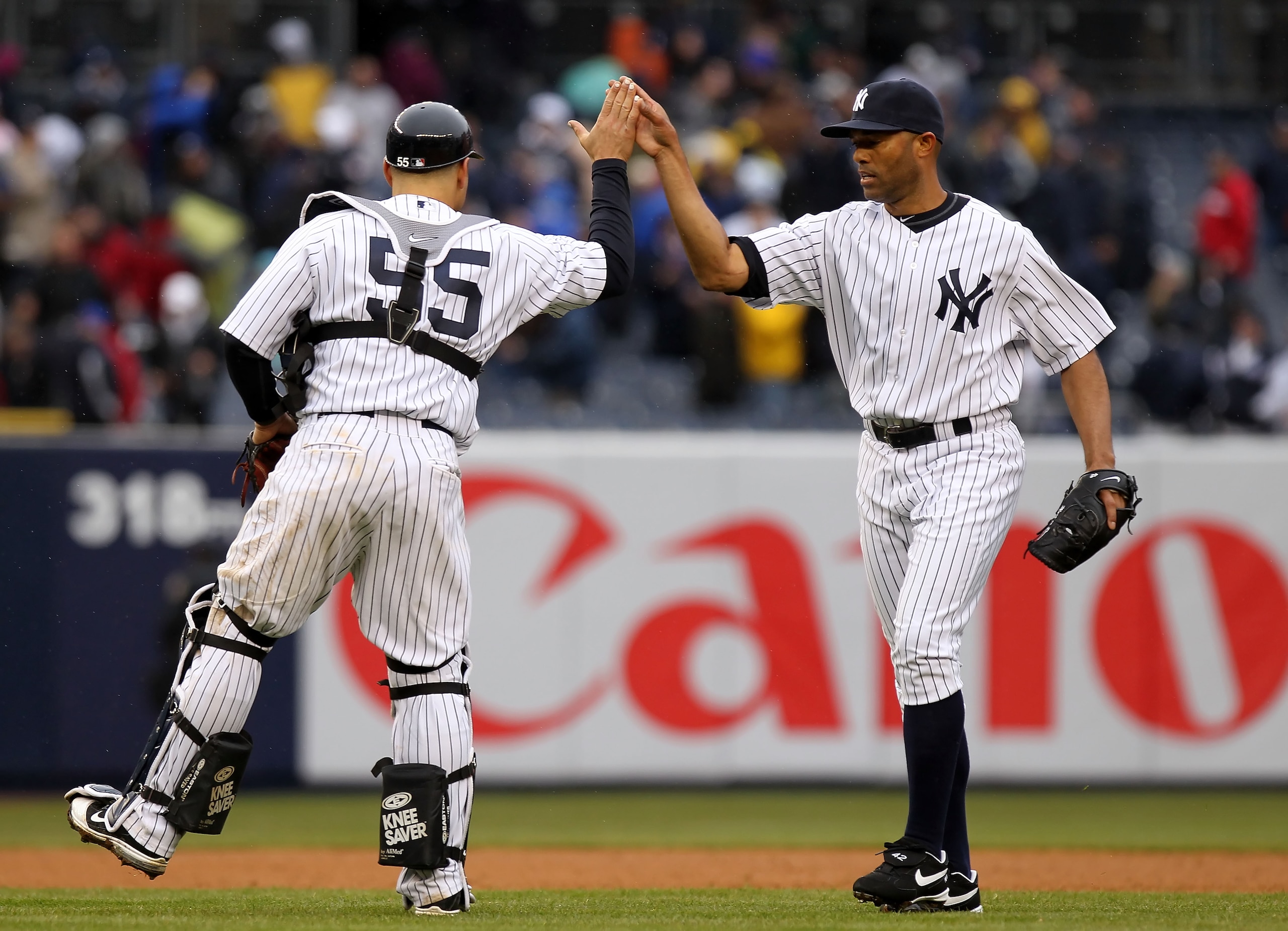 NEW YORK, NY - MARCH 31: Russell Martin #55 and Mariano Rivera #42 of the New York Yankees celebrate their 6-3 win over the Detroit Tigers on Opening Day at Yankee Stadium on March 31, 2011 in the Bronx borough of New York City. (Photo by Nick Laham/Get NEW YORK, NY - MARCH 31: Russell Martin #55 and Mariano Rivera #42 of the New York Yankees celebrate their 6-3 win over the Detroit Tigers on Opening Day at Yankee Stadium on March 31, 2011 in the Bronx borough of New York City. (Photo by Nick Laham/Get