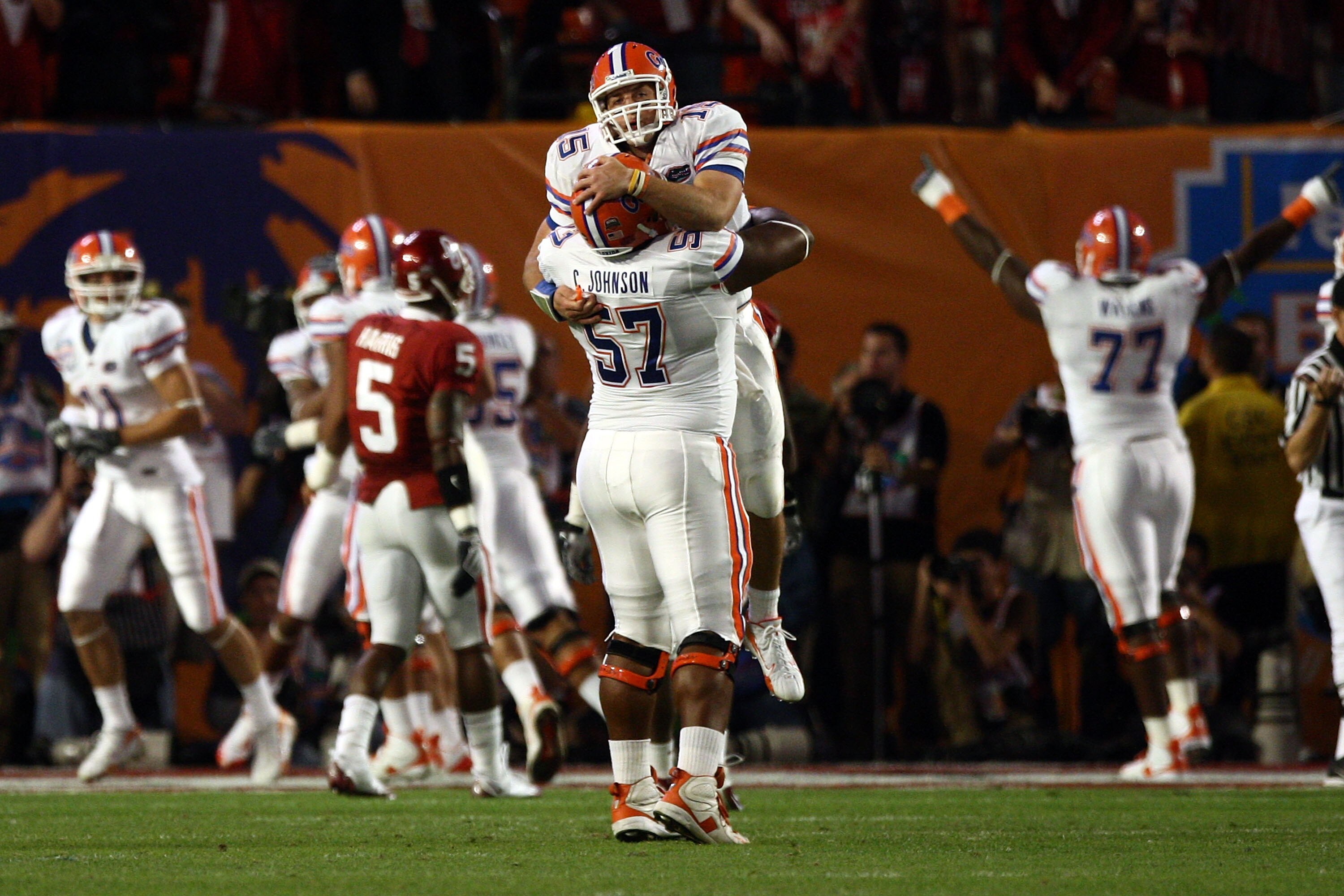 MIAMI - JANUARY 08:  Quarterback Tim Tebow of the Florida Gators celebrates with teammate Carl Johnson #57 after throwing for a touchdown against the Oklahoma Sooners in the FedEx BCS National Championship Game at Dolphin Stadium on January 8, 2009 in Mia