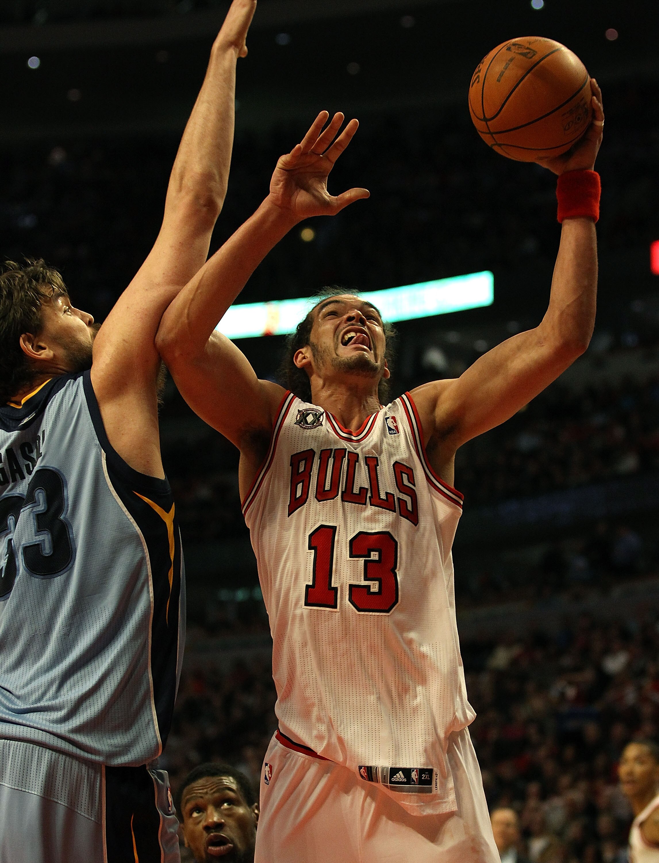 CHICAGO, IL - MARCH 25: Joakim Noah #13 of the Chicago Bulls puts up a shot against Marc Gasol #33 of the Memphis Girzzlies at the United Center on March 25, 2011 in Chicago, Illinois. The Bulls defeated the Grizzlies 99-96. NOTE TO USER: User expressly a