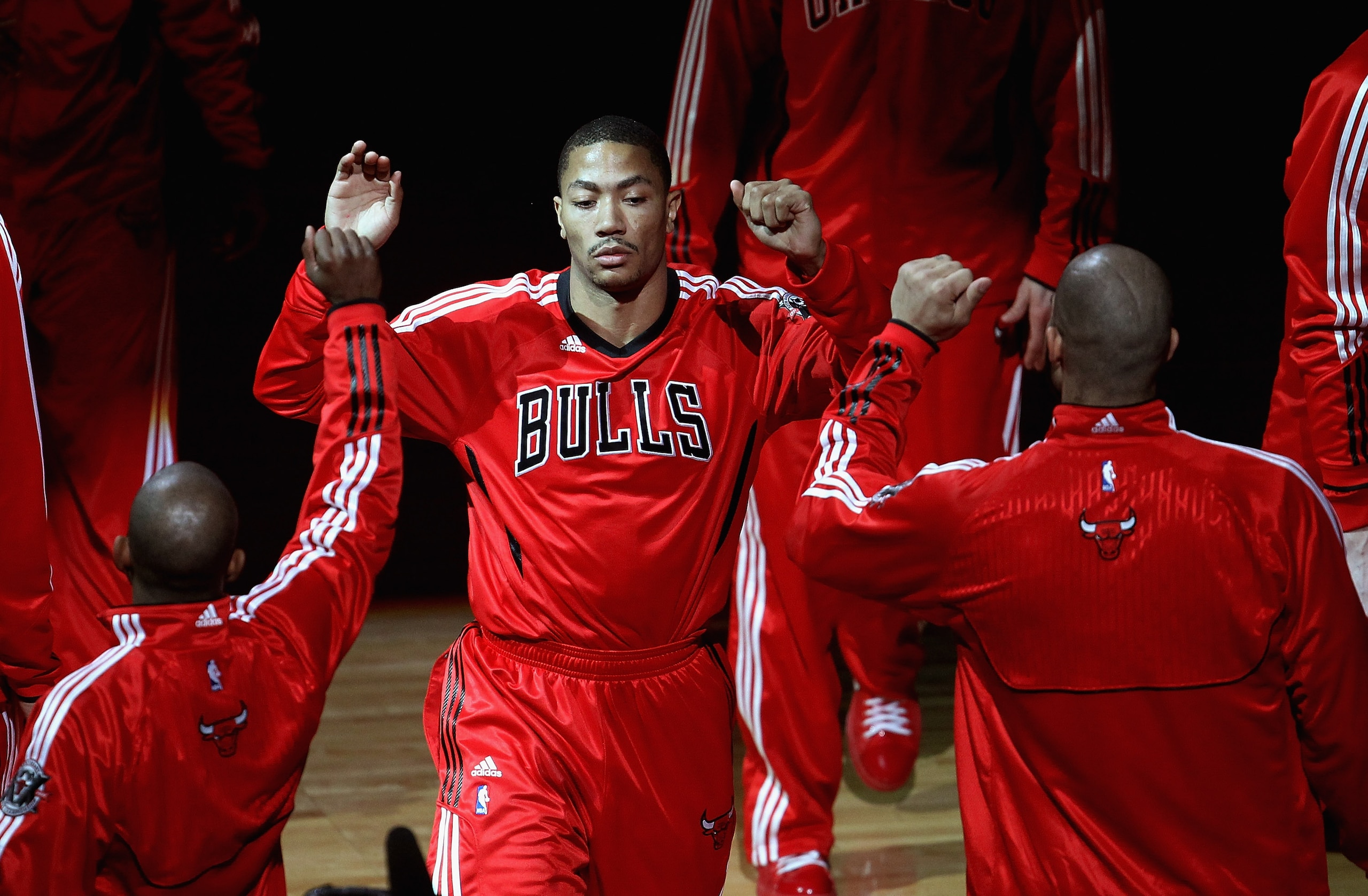 CHICAGO, IL - APRIL 13: Derrick Rose #1 of the Chicago Bulls is greeted by teammates during player introductions before a game against the New Jersey Nets at United Center on April 13, 2011 in Chicago, Illinois. The Bulls defeated the Nets 97-92. NOTE TO