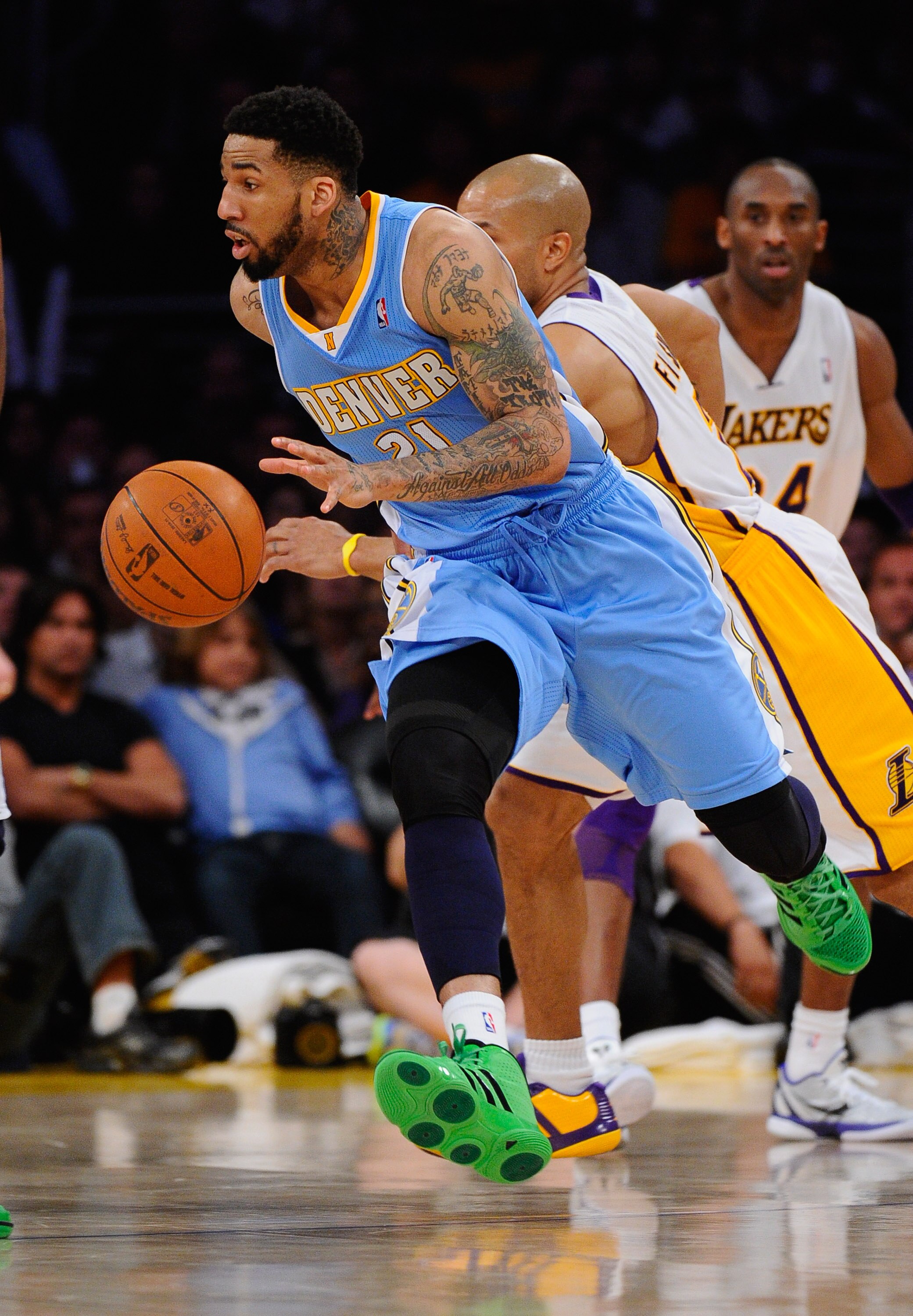 LOS ANGELES, CA - APRIL 03: Wilson Chandler #21 of the Denver Nuggets  drives past Derek Fisher #2 of the Los Angeles Lakers during the game at Staples Center on April 3, 2011 in Los Angeles, California. NOTE TO USER: User expressly acknowledges and agree