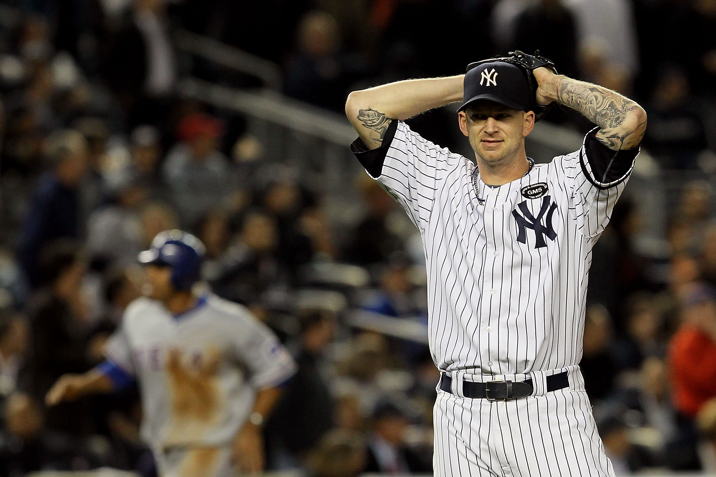 NEW YORK - OCTOBER 19: A.J. Burnett #34 of the New York Yankees reacts after giving up a three-run home run to Bengie Molina #11 of the Texas Rangers in the top of the sixth inning in Game Four of the ALCS during the 2010 MLB Playoffs at Yankee Stadium o NEW YORK - OCTOBER 19: A.J. Burnett #34 of the New York Yankees reacts after giving up a three-run home run to Bengie Molina #11 of the Texas Rangers in the top of the sixth inning in Game Four of the ALCS during the 2010 MLB Playoffs at Yankee Stadium o