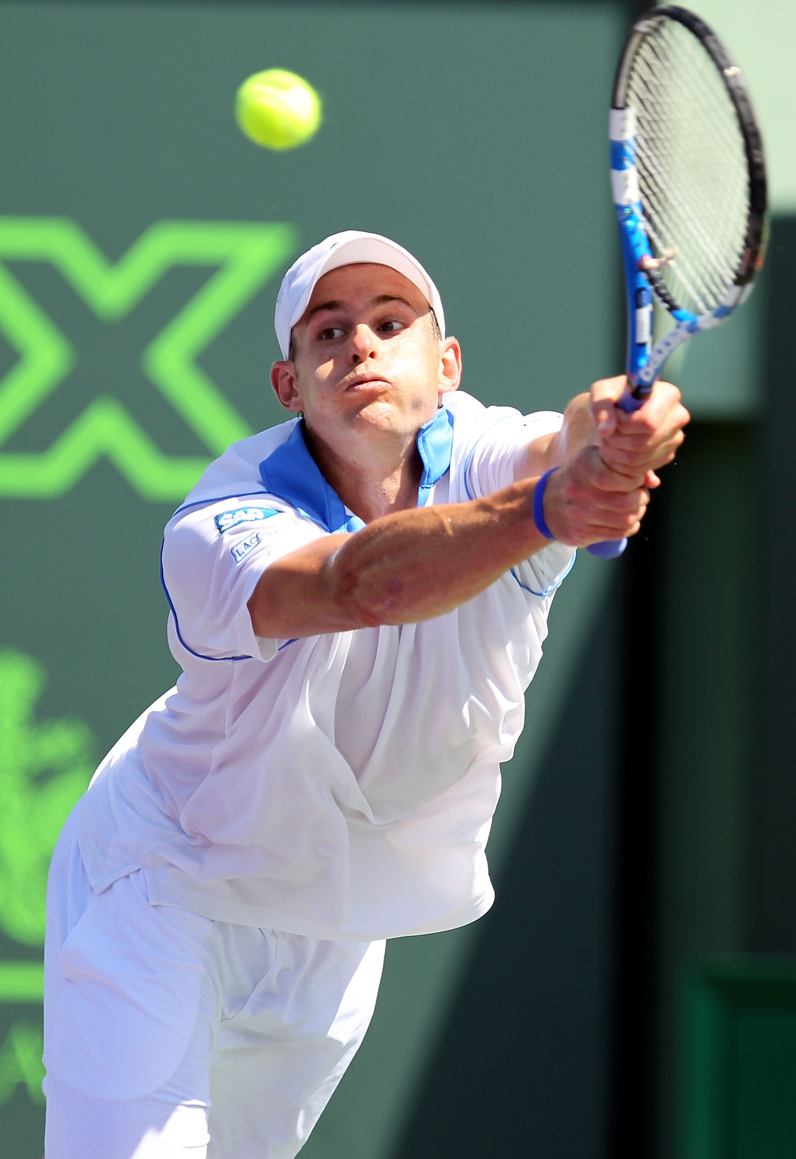 KEY BISCAYNE, FL - MARCH 26:  Andy Roddick hits a return against Pablo Cuevas of Uruguay during the Sony Ericsson Open at Crandon Park Tennis Center on March 26, 2011 in Key Biscayne, Florida.  (Photo by Al Bello/Getty Images)