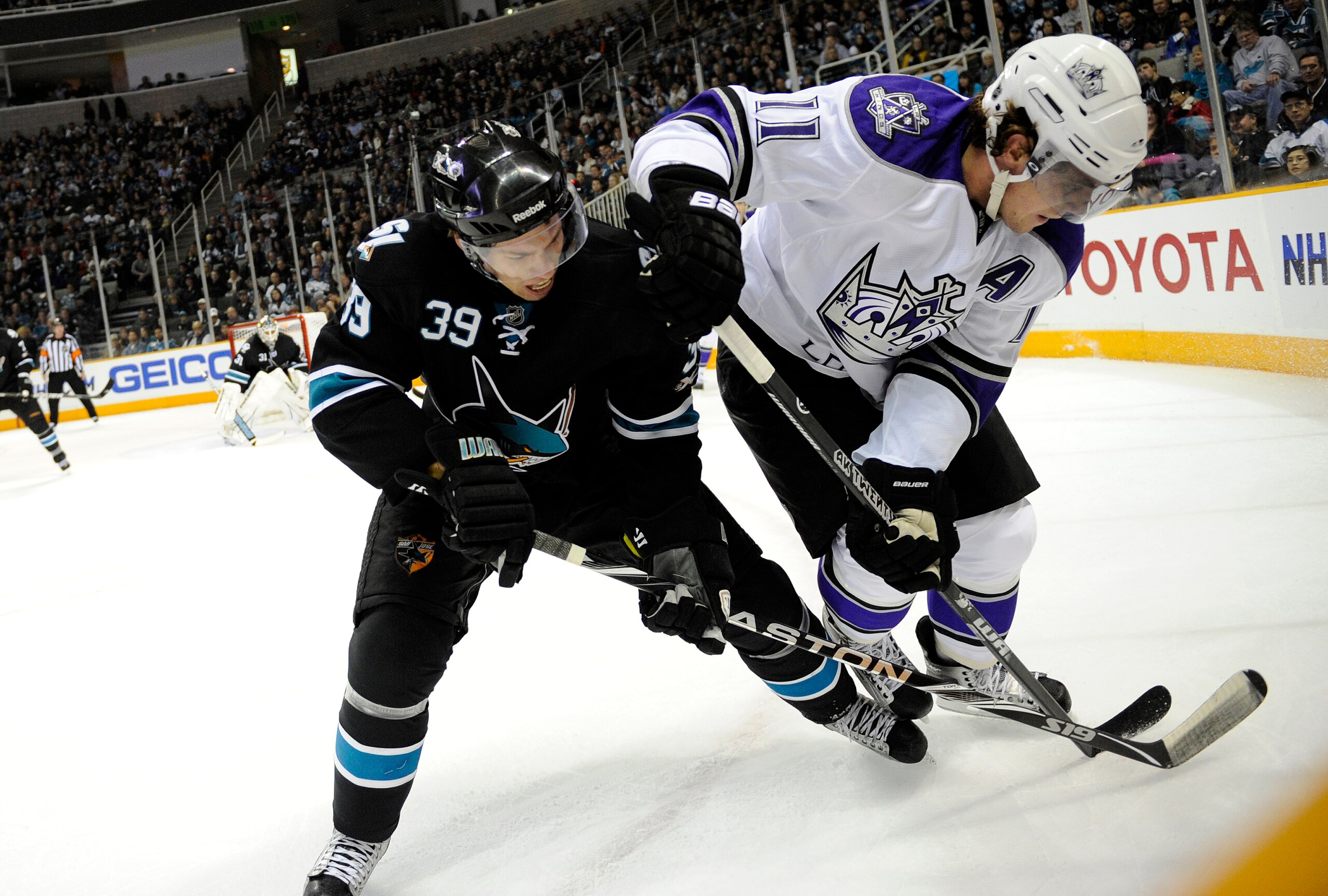 SAN JOSE, CA - DECEMBER 27: Anze Kopitar #11 of the Los Angeles Kings battles for the puck with Logan Couture #39 of the San Jose Sharks during an NHL hockey game at the HP Pavilion on December 27, 2010 in San Jose, California. The Kings won the game 4-0. SAN JOSE, CA - DECEMBER 27: Anze Kopitar #11 of the Los Angeles Kings battles for the puck with Logan Couture #39 of the San Jose Sharks during an NHL hockey game at the HP Pavilion on December 27, 2010 in San Jose, California. The Kings won the game 4-0.