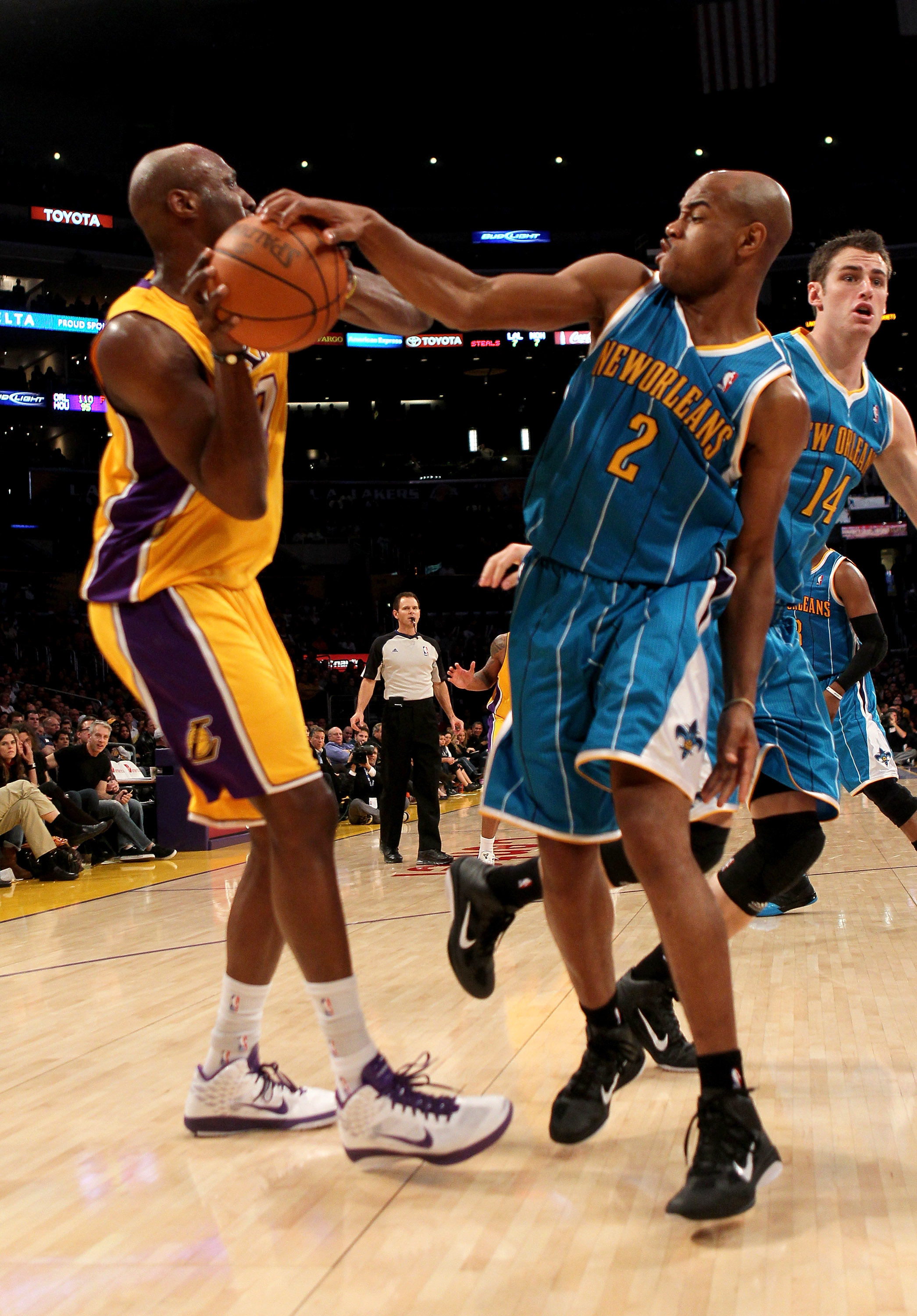 LOS ANGELES, CA - JANUARY 7:   Jarrett Jack #2 of the New Orleans Hornets gets a hand on the ball as he defends against Lamar Odom #7 of the Los Angeles Lakers at Staples Center on January 7, 2011 in Los Angeles, California.  The Lakers won 101-97.  NOTE