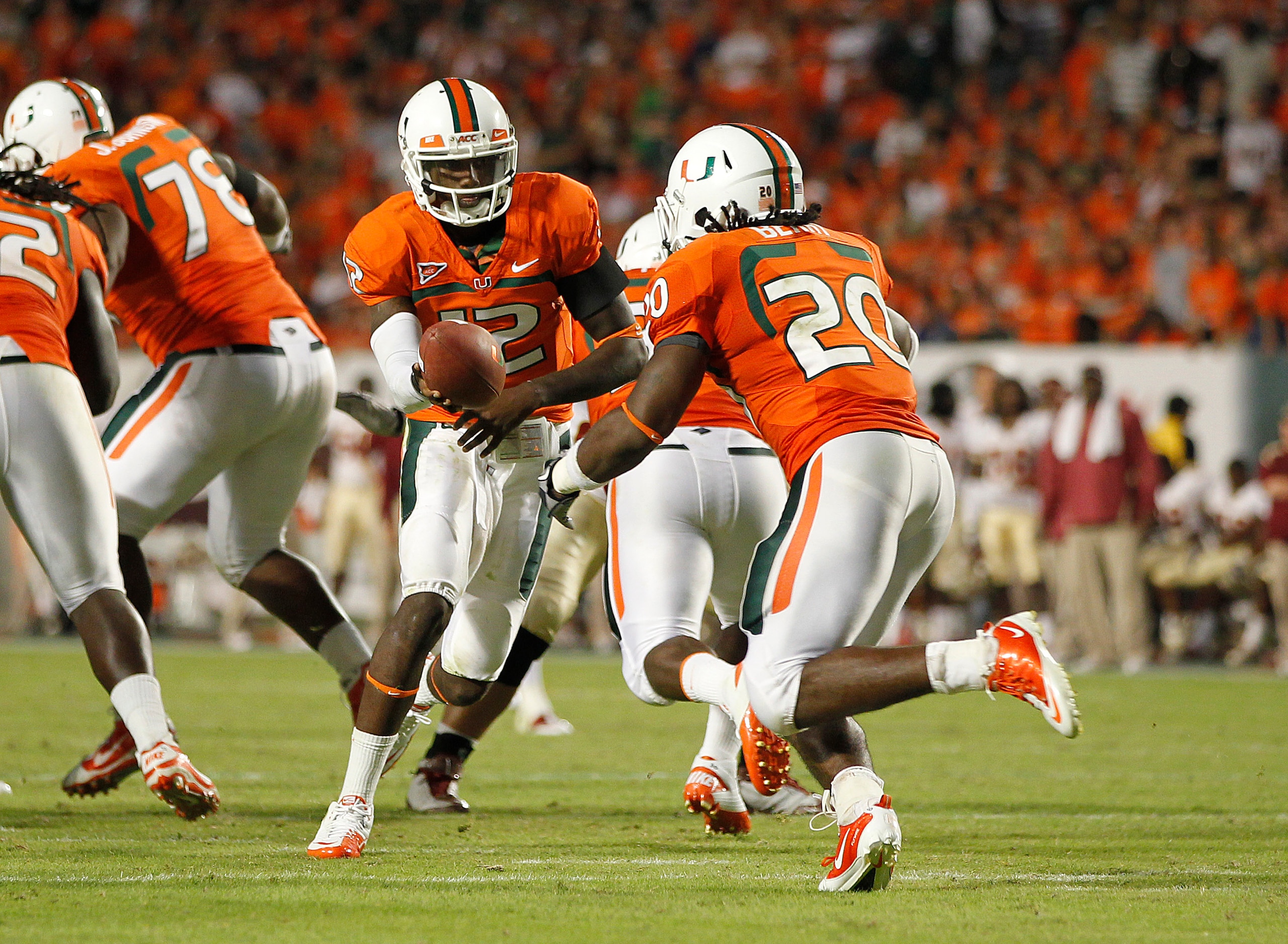 MIAMI, FL - OCTOBER 9: Jacory Harris #12 hands the ball off to Damien Berry #20 of the Miami Hurricanes against the Florida State Seminoles on October 9, 2010 at Sun Life Stadium in Miami, Florida. The Seminoles defeated the Hurricanes 45-17. (Photo by Jo