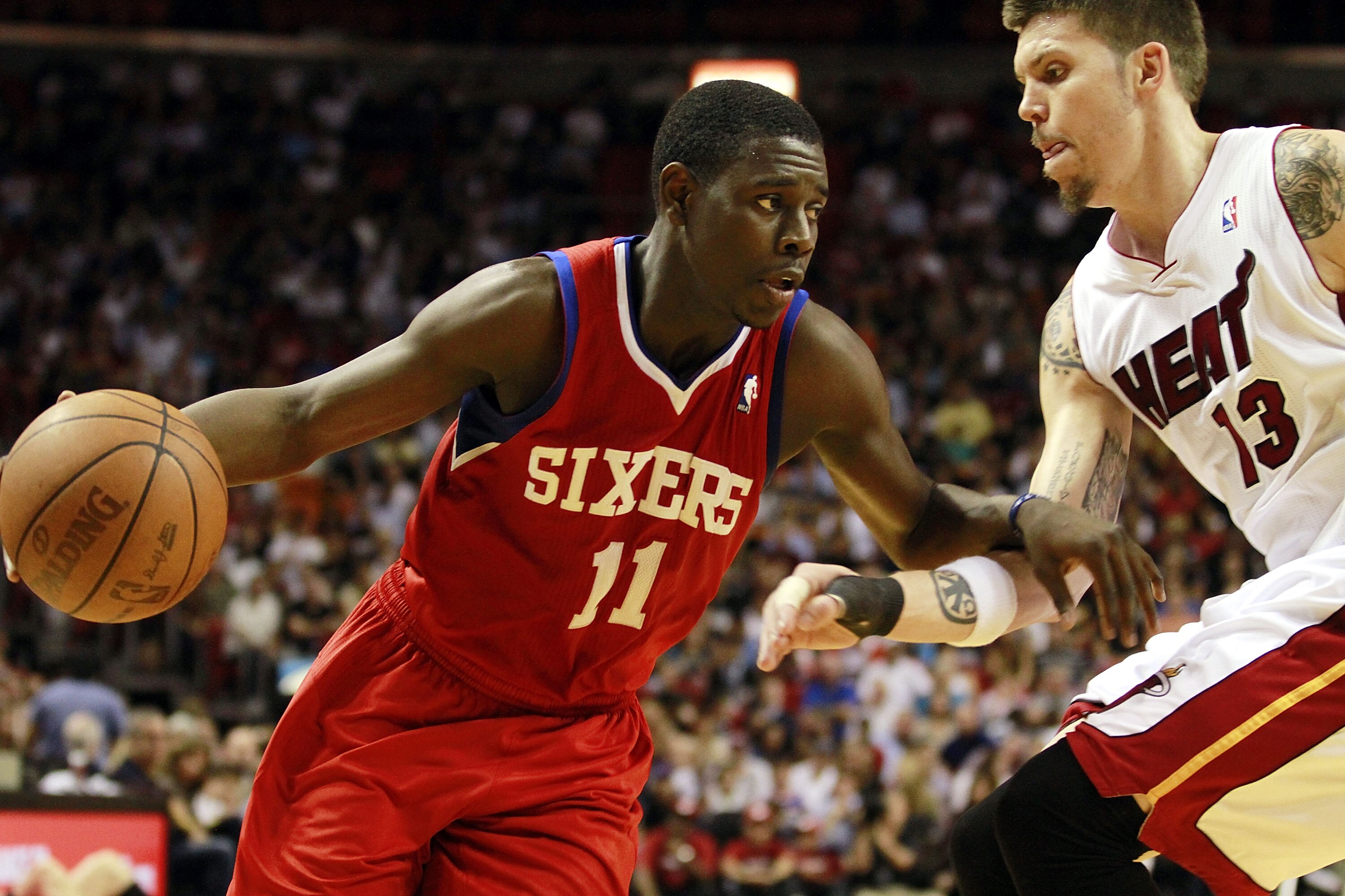 MIAMI, FL - MARCH 25:  Forward Mike Miller #13 of the Miami Heat defends against Guard Jrue Holiday #11 of the Philadelphia Sixers at American Airlines Arena on March 25, 2011 in Miami, Florida. NOTE TO USER: User expressly acknowledges and agrees that, b
