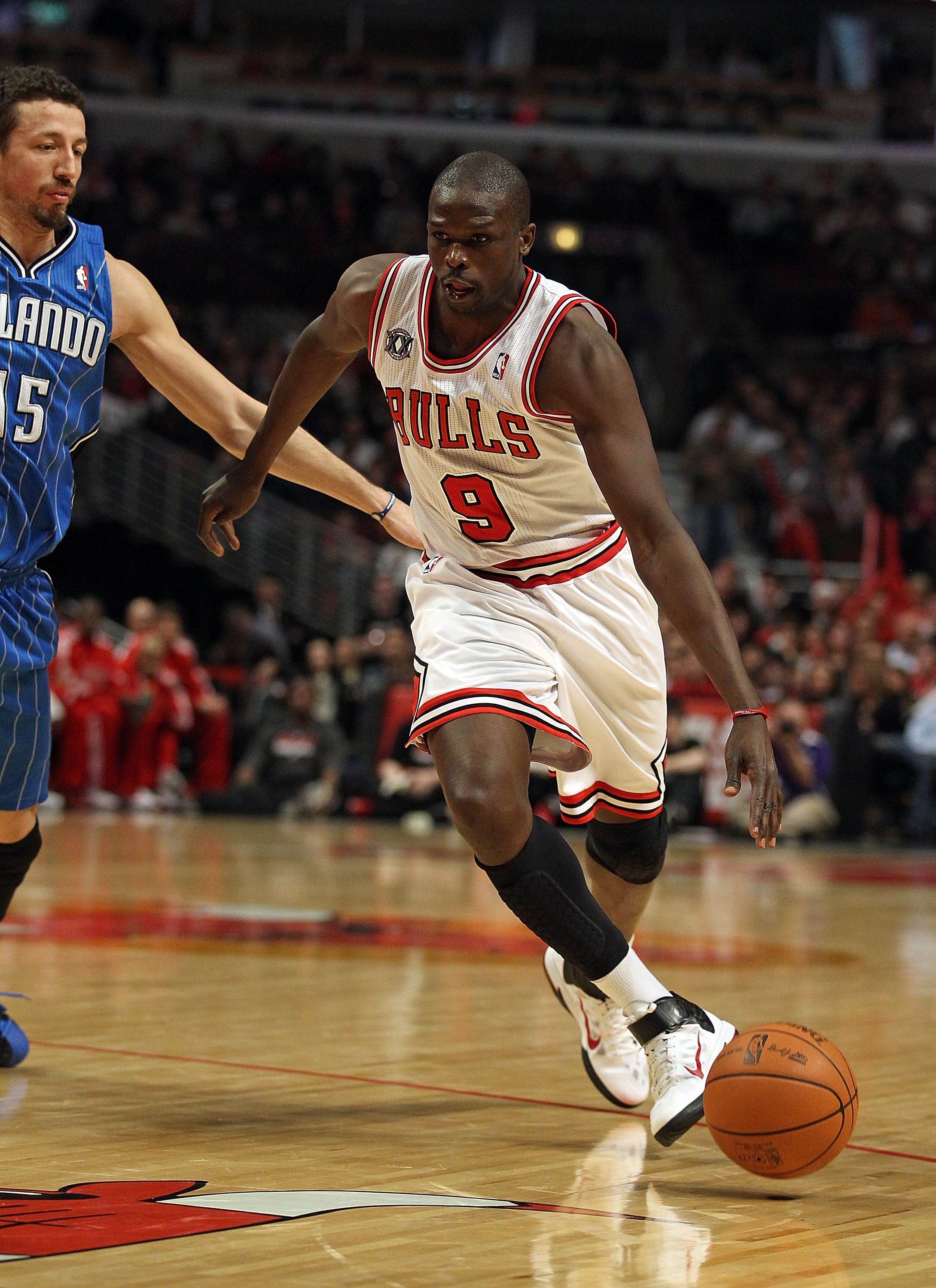 CHICAGO, IL - JANUARY 28: Loul Deng #9 of the Chicago Bulls drives past Hedo Turkoglu #15 of the Orlando Magic at the United Center on January 28, 2011 in Chicago, Illinois. The Bulls defeated the Magic 99-90. NOTE TO USER: User expressly acknowledges and