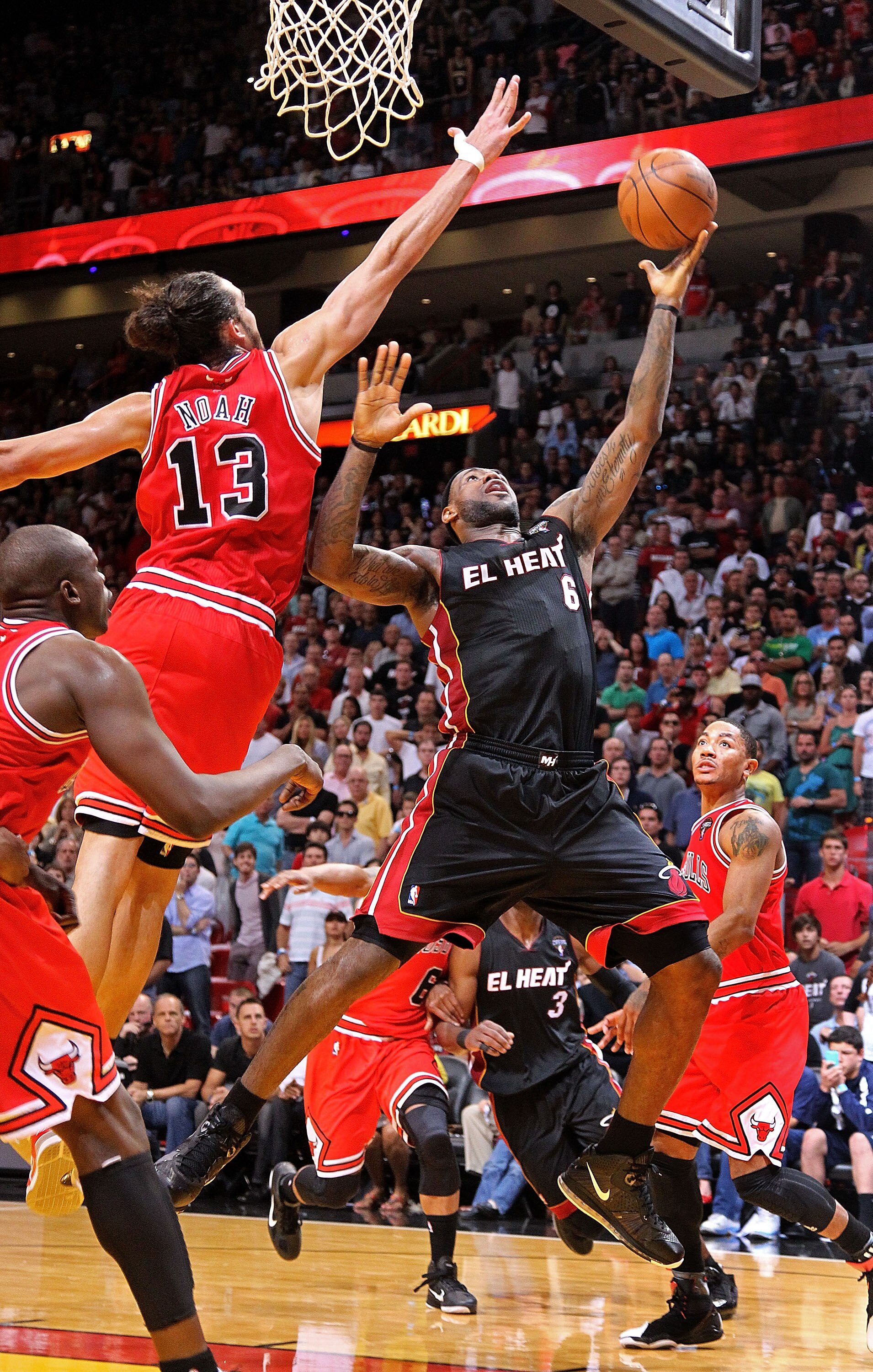MIAMI, FL - MARCH 06:  LeBron James #6 of the Miami Heat shoots over Joakim Noah #13 of the Chicago Bulls during a game at American Airlines Arena on March 6, 2011 in Miami, Florida. NOTE TO USER: User expressly acknowledges and agrees that, by downloadin