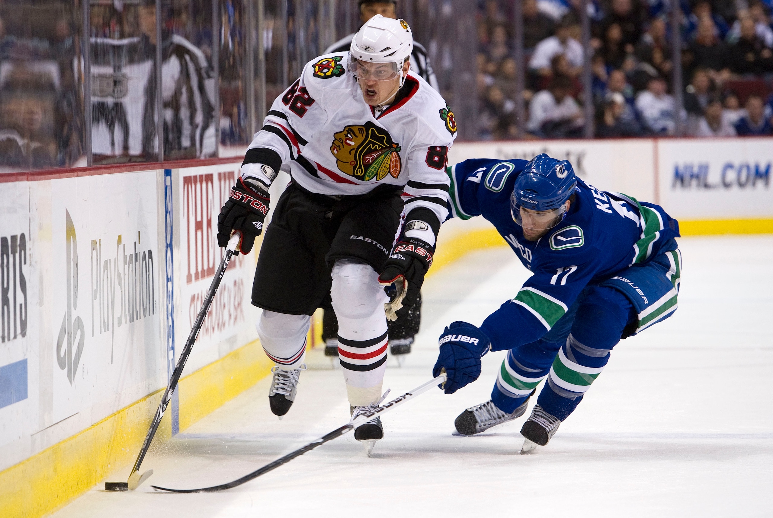 VANCOUVER, CANADA - FEBRUARY 4: Ryan Kesler #17 of the Vancouver Canucks tries to poke the puck away from Tomas Kopecky #82 of the Chicago Blackhawks during the first period in NHL action on February 04, 2011 at Rogers Arena in Vancouver, British Columbia VANCOUVER, CANADA - FEBRUARY 4: Ryan Kesler #17 of the Vancouver Canucks tries to poke the puck away from Tomas Kopecky #82 of the Chicago Blackhawks during the first period in NHL action on February 04, 2011 at Rogers Arena in Vancouver, British Columbia