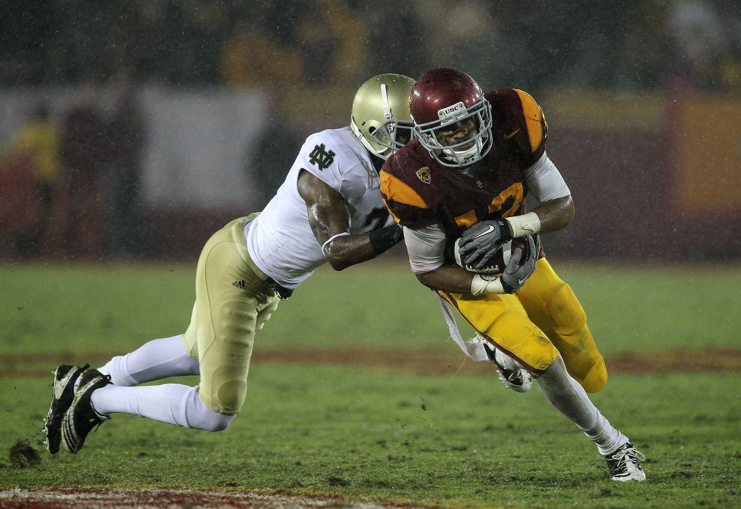 LOS ANGELES - NOVEMBER 27: Wide receiver Robert Woods #13 of the USC Trojans carries the ball against cornerback Darrin Walls #2 of the Notre Dame Fighting Irish at the Los Angeles Memorial Coliseum on November 27, 2010 in Los Angeles, California. Notre LOS ANGELES - NOVEMBER 27: Wide receiver Robert Woods #13 of the USC Trojans carries the ball against cornerback Darrin Walls #2 of the Notre Dame Fighting Irish at the Los Angeles Memorial Coliseum on November 27, 2010 in Los Angeles, California. Notre