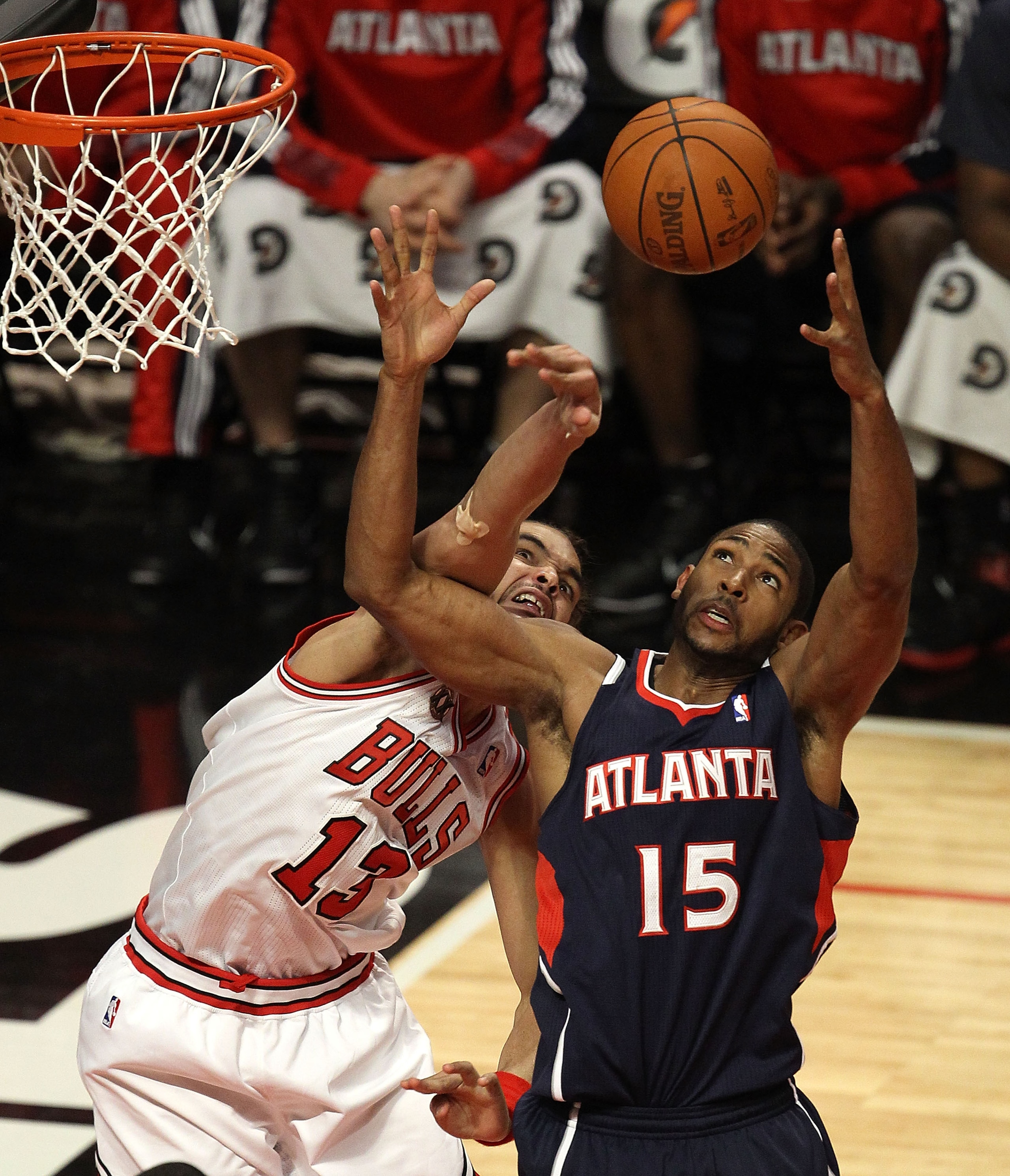 CHICAGO, IL - MARCH 11: Joakim Noah #13 of the Chicago Bulls knocks the ball away from Al Horford #15 of the Atlanta Hawks at the United Center on March 11, 2011 in Chicago, Illinois. The Bulls defeated the Hawks 94-76. NOTE TO USER: User expressly acknow