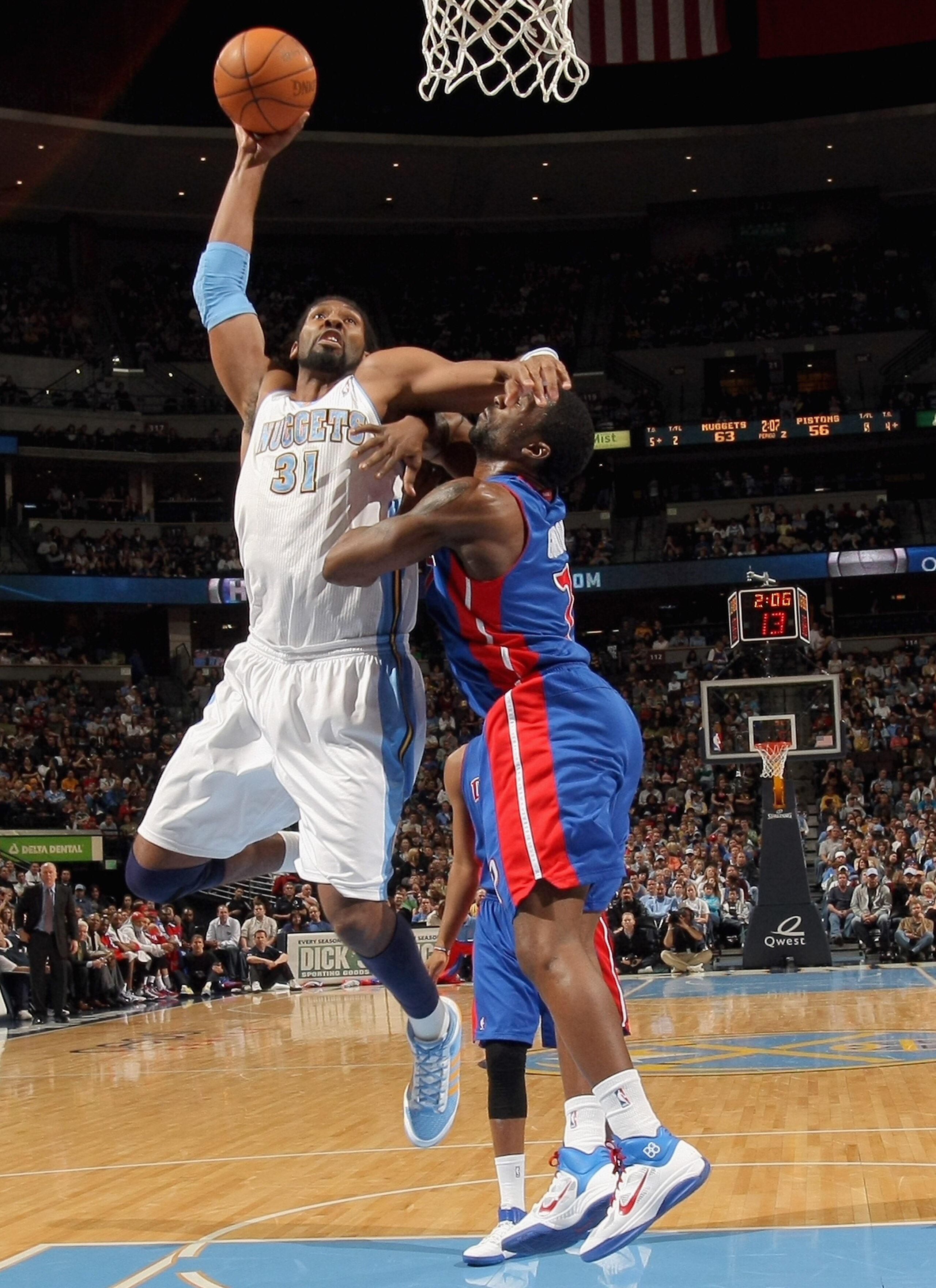 DENVER, CO - MARCH 12:  Nene #31 of the Denver Nuggets is fouled by Ben Gordon #7 of the Detroit Pistons as he goes to the basket at the Pepsi Center on March 12, 2011 in Denver, Colorado. NOTE TO USER: User expressly acknowledges and agrees that, by down