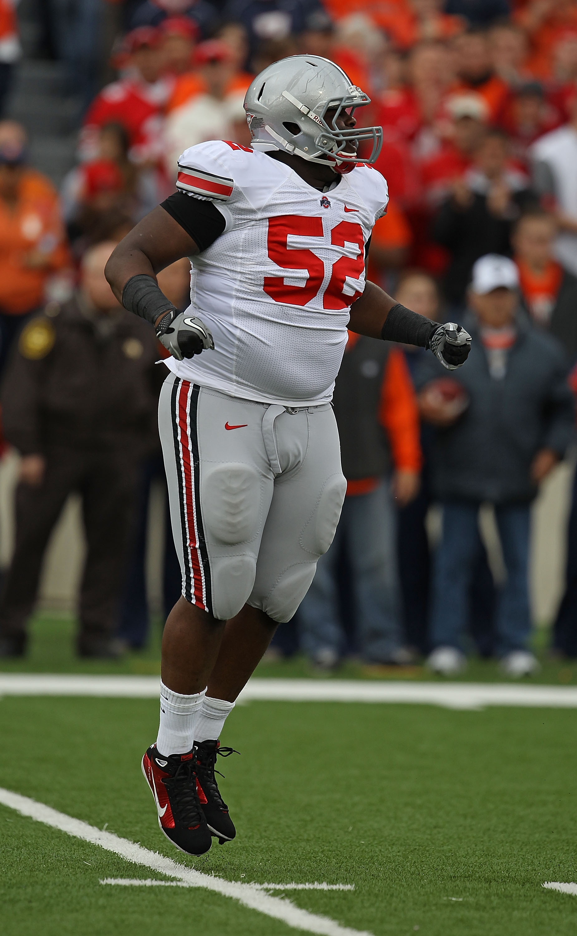 CHAMPAIGN, IL - OCTOBER 02: Johnathan Hankins #52 of the Ohio State Buckeyes hops in celebration after a defensive play against the Illinois Fighting Illini at Memorial Stadium on October 2, 2010 in Champaign, Illinois. Ohio State defeated Illinois 24-13.