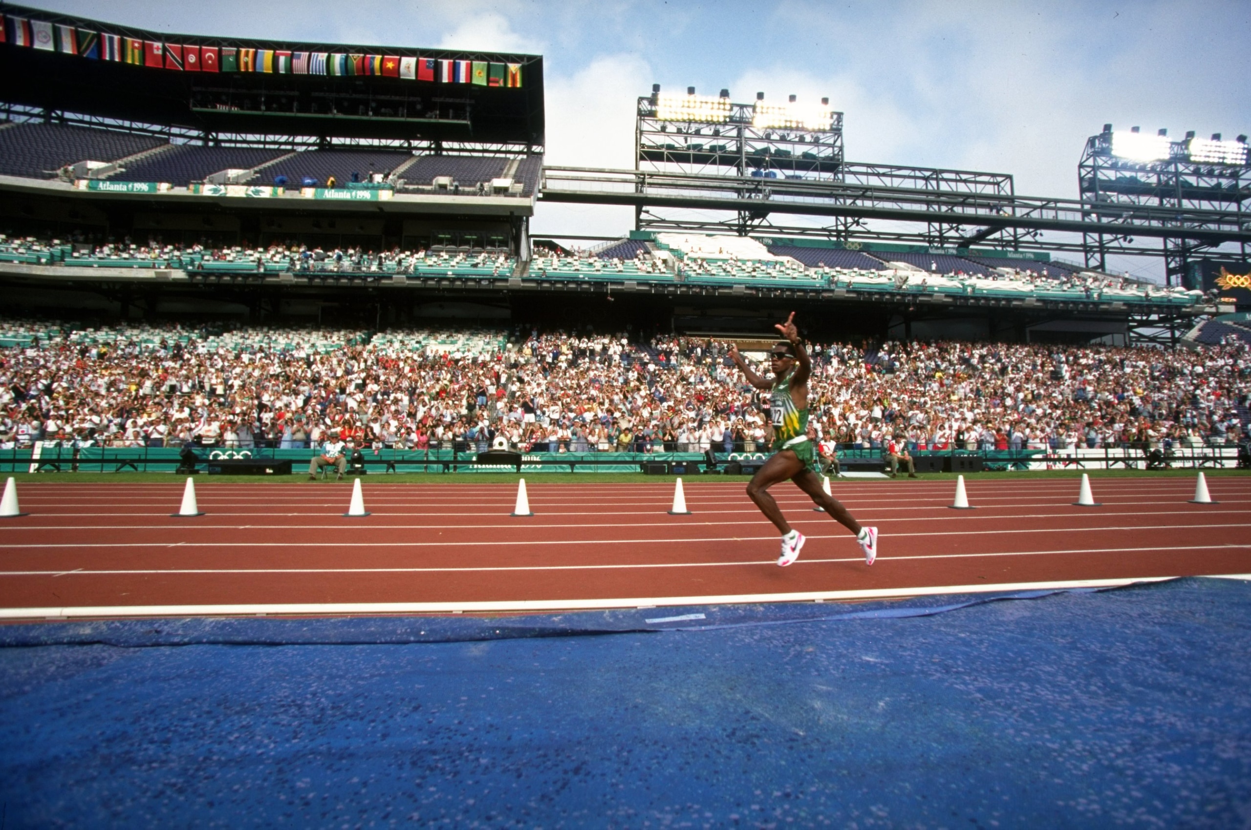 4 Aug 1996:   Josia Thugwane of South Africa celebrates as he enters the stadium during the men's marathon at the Centennial Olympic Games in Atlanta, Georgia. Thugwane won gold.  \ Mandatory Credit: Mike Powell /Allsport