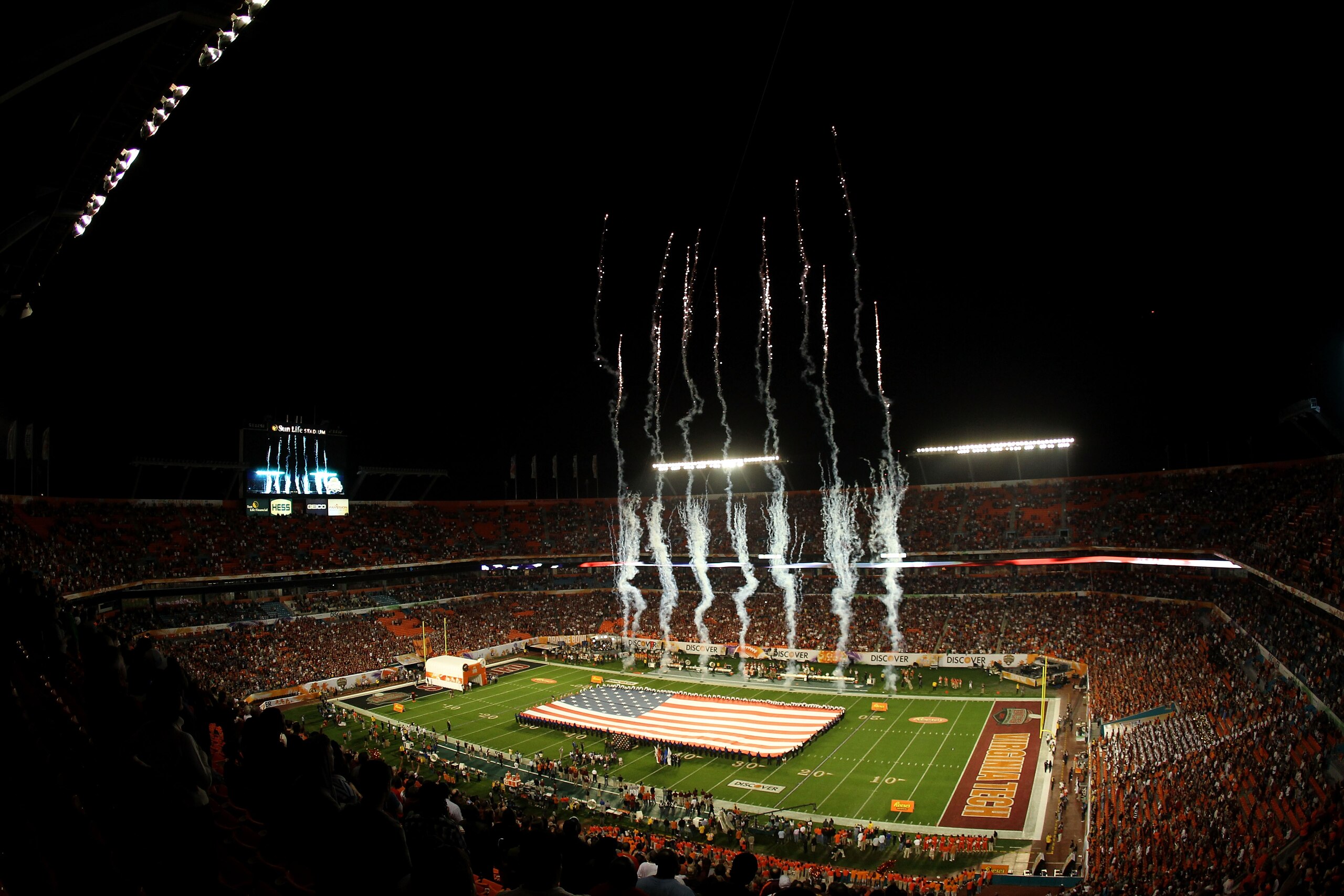 MIAMI, FL - JANUARY 03:  A general view of fireworks set off over a giant American Flag during the performance of the National Anthem prior to the Stanford Cardinal playing against the Virginia Tech Hokies during the 2011 Discover Orange Bowl at Sun Life