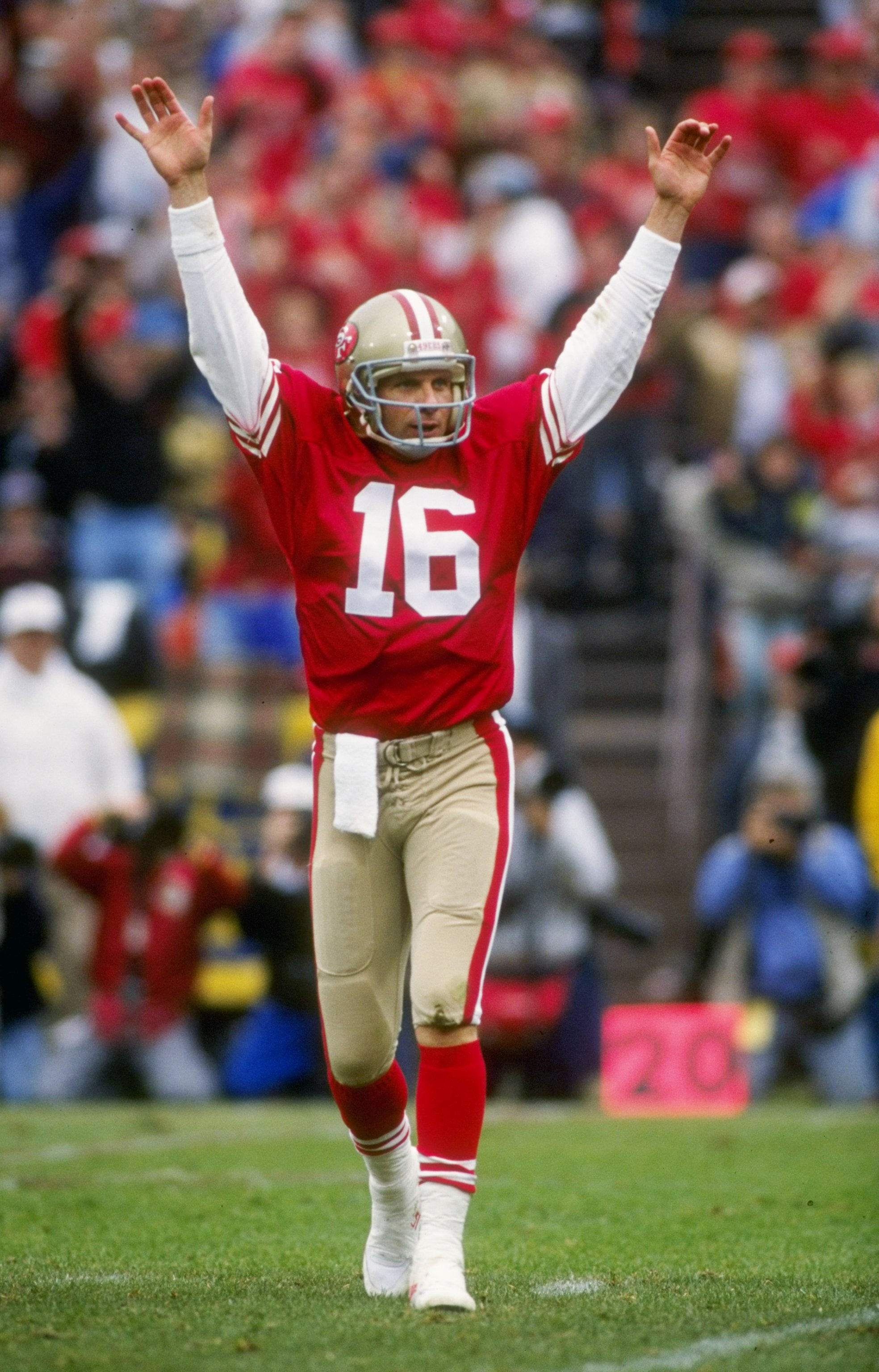 Quarterback John Elway raises his hands in victory after he is