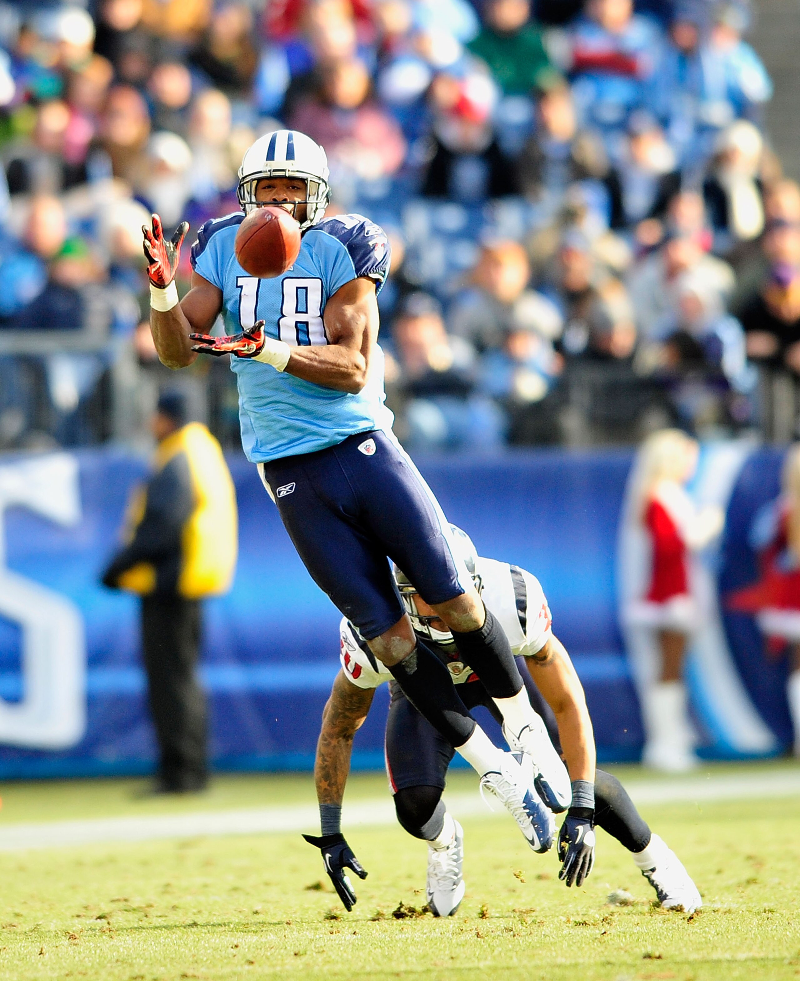 NASHVILLE, TN - DECEMBER 19:  Kenny Britt #18 of the Tennessee Titans makes a catch as Jason Allen #30 of the Houston Texans defends at LP Field on December 19, 2010 in Nashville, Tennessee. The Titans defeated the Texans, 31-17.  (Photo by Grant Halverso