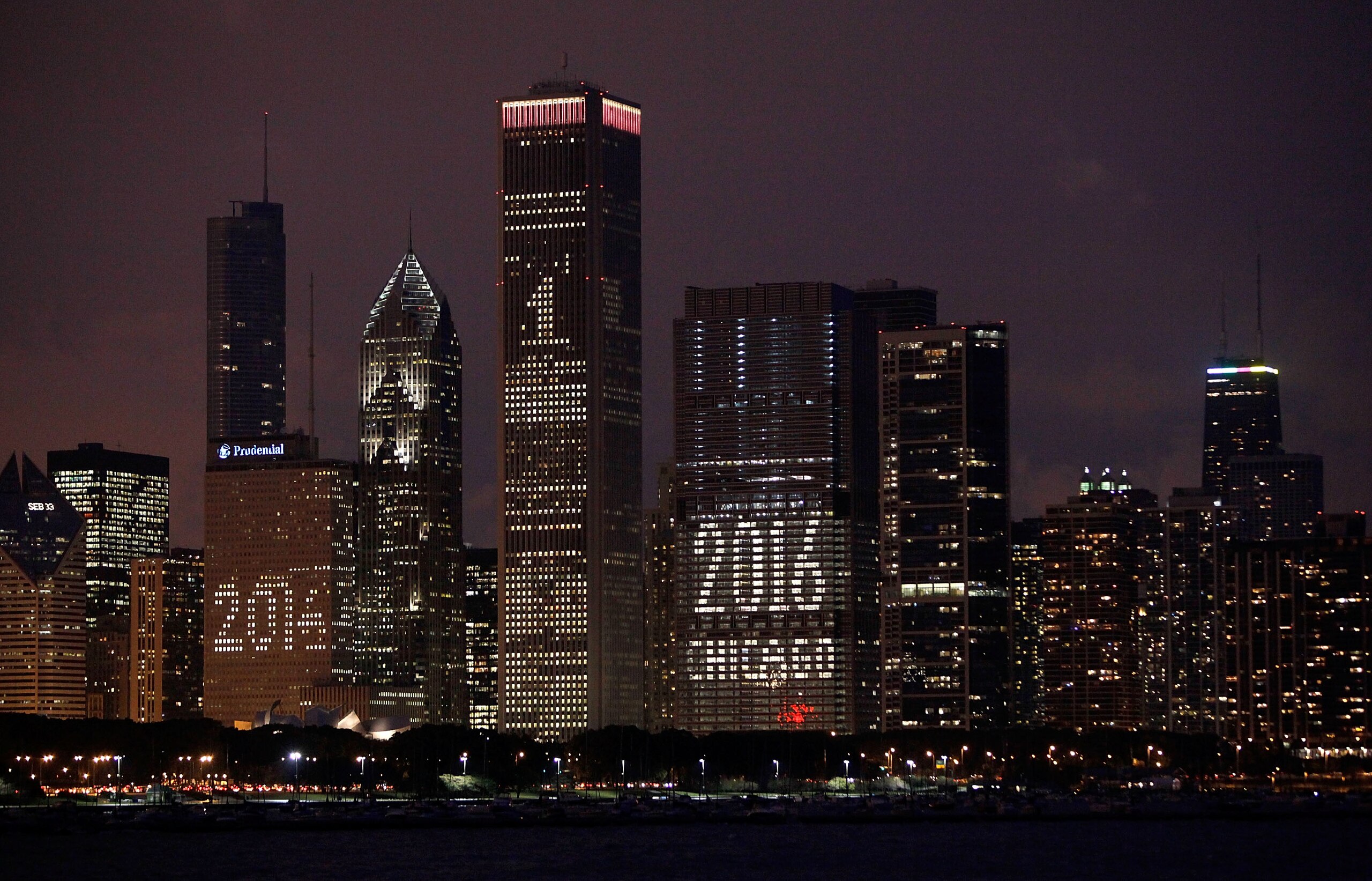 CHICAGO - OCTOBER 01:  The Chicago skyline is lit up with support for the city's bid to host the 2016 Olympics October 1, 2009 in Chicago, Illinois. The city is hosting a party in Daley Plaza tomorrow so residents can watch live as the International Olymp