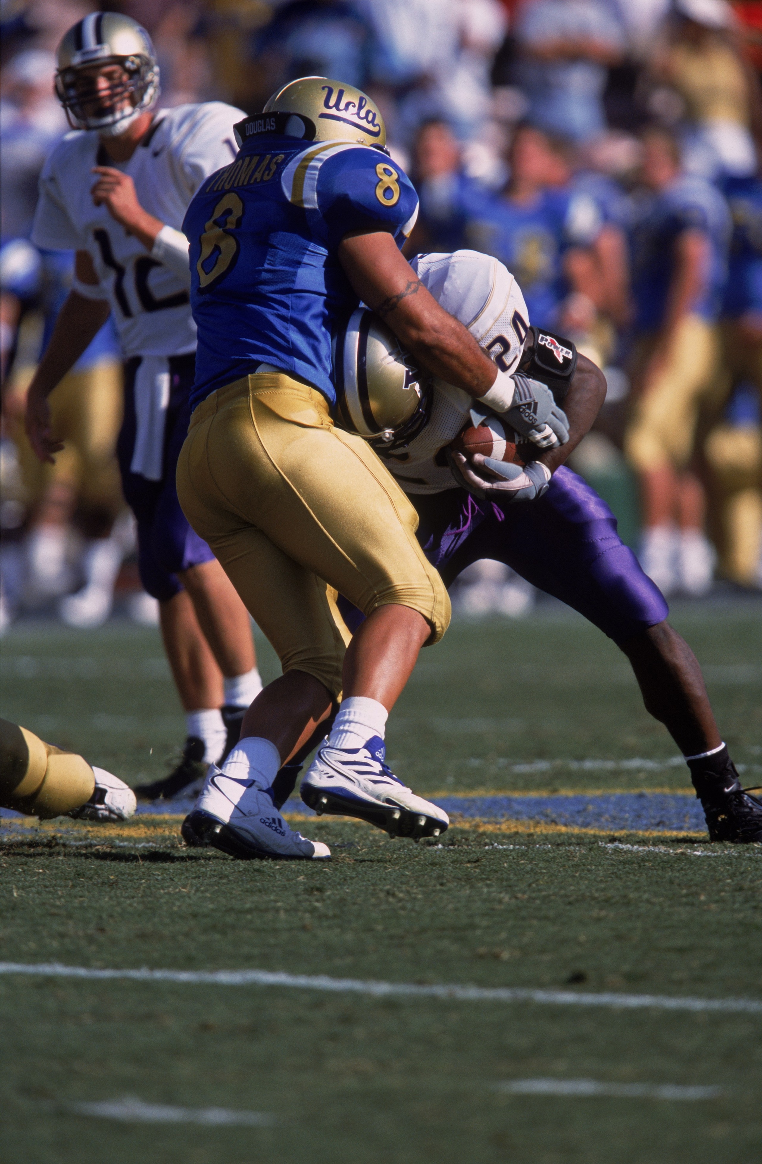 13 Oct 2001:  Robert Thomas #8 of the University of California Los Angeles (UCLA) Bruins goes head to head against Rich Alexis #24 of the Washington Huskies during the game at the Rose Bowl in Pasadena, California. The Bruins defeated the Huskies 35-13. M