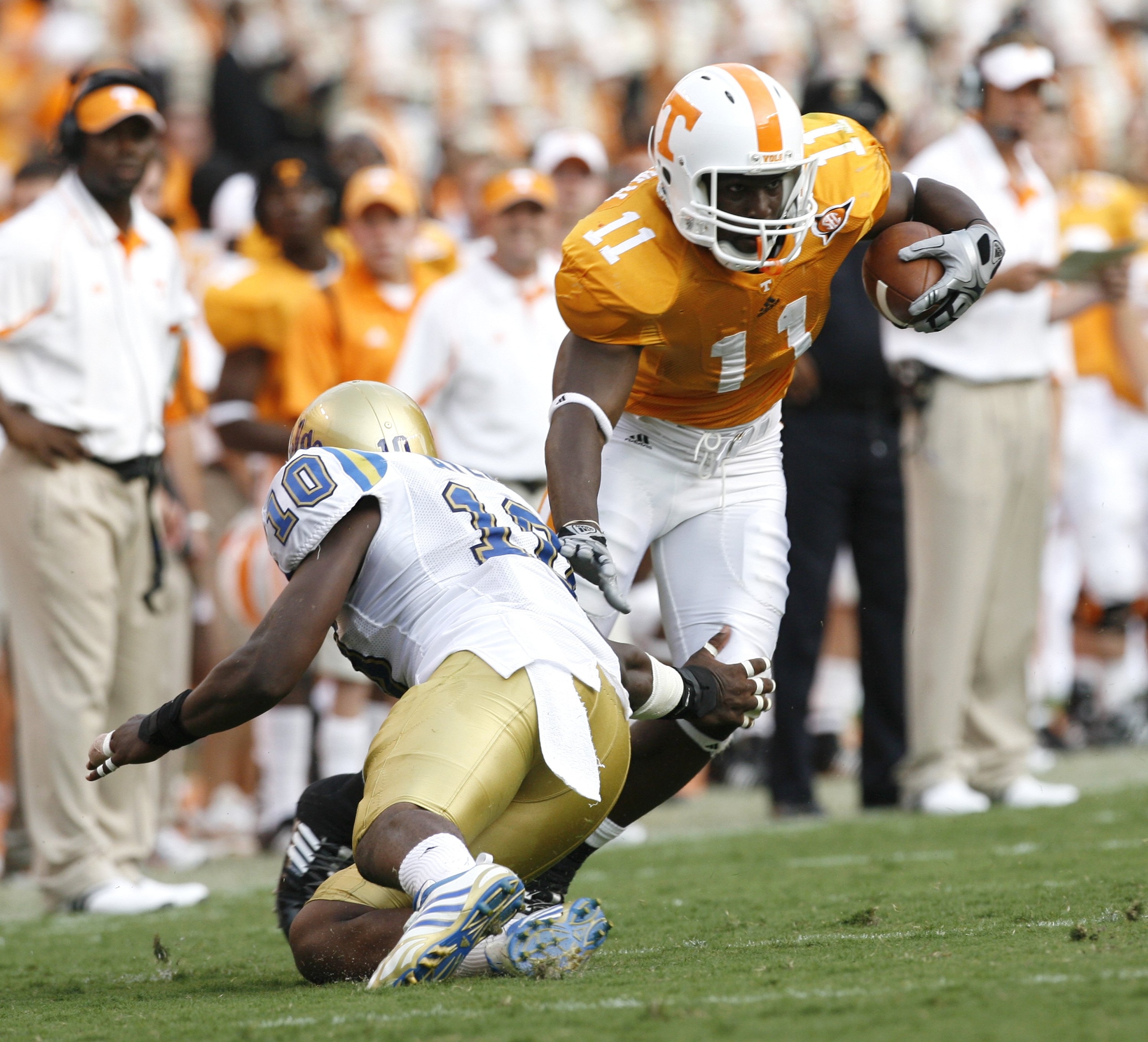 KNOXVILLE, TN - SEPTEMBER 12: Bryce Brown #11 of the Tennessee Volunteers breaks a tackle against Akeem Ayers #10 of the UCLA Bruins on September 12, 2009 at Neyland Stadium in Knoxville, Tennessee. UCLA beat Tennessee 19-15. (Photo by Joe Murphy/Getty Im
