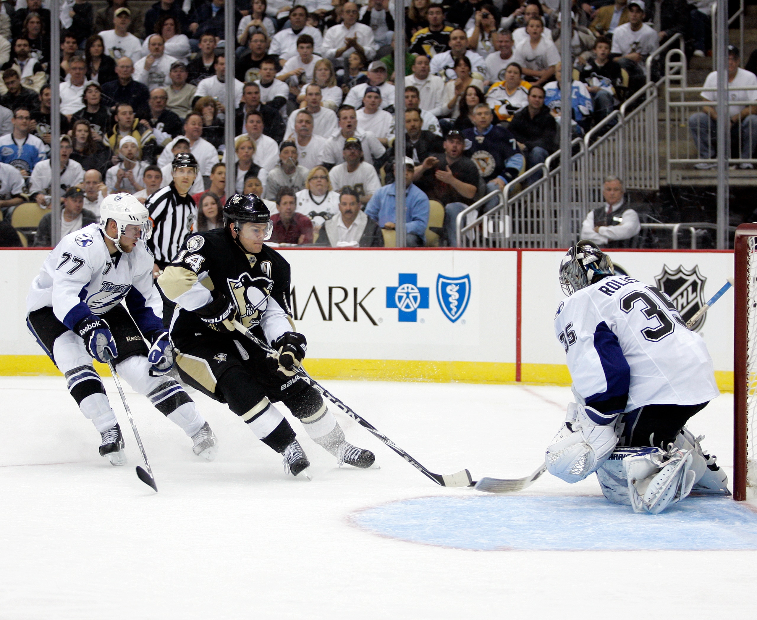 PITTSBURGH, PA - APRIL 13: Dwayne Roloson #35 of the Tampa Bay Lightning makes a save on Chris Kunitz #14 of the Pittsburgh Penguins as he is defended by Victor Hedman #77 in Game One of the Eastern Conference Quarterfinals during the 2011 NHL Stanley Cup