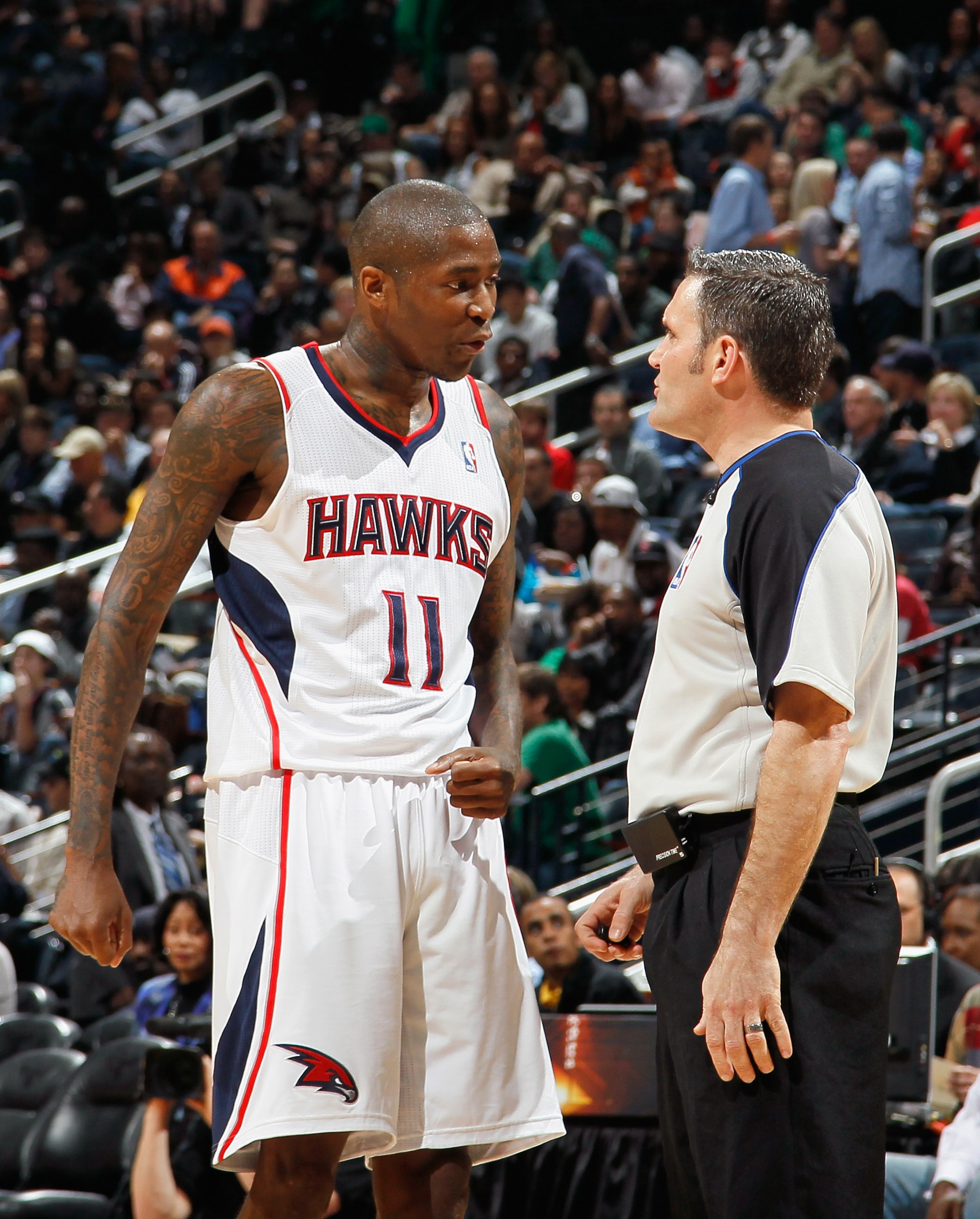 ATLANTA, GA - APRIL 01:  Jamal Crawford #11 of the Atlanta Hawks converses with referee Monty McCutchen #13 against the Boston Celtics at Philips Arena on April 1, 2011 in Atlanta, Georgia.  NOTE TO USER: User expressly acknowledges and agrees that, by do