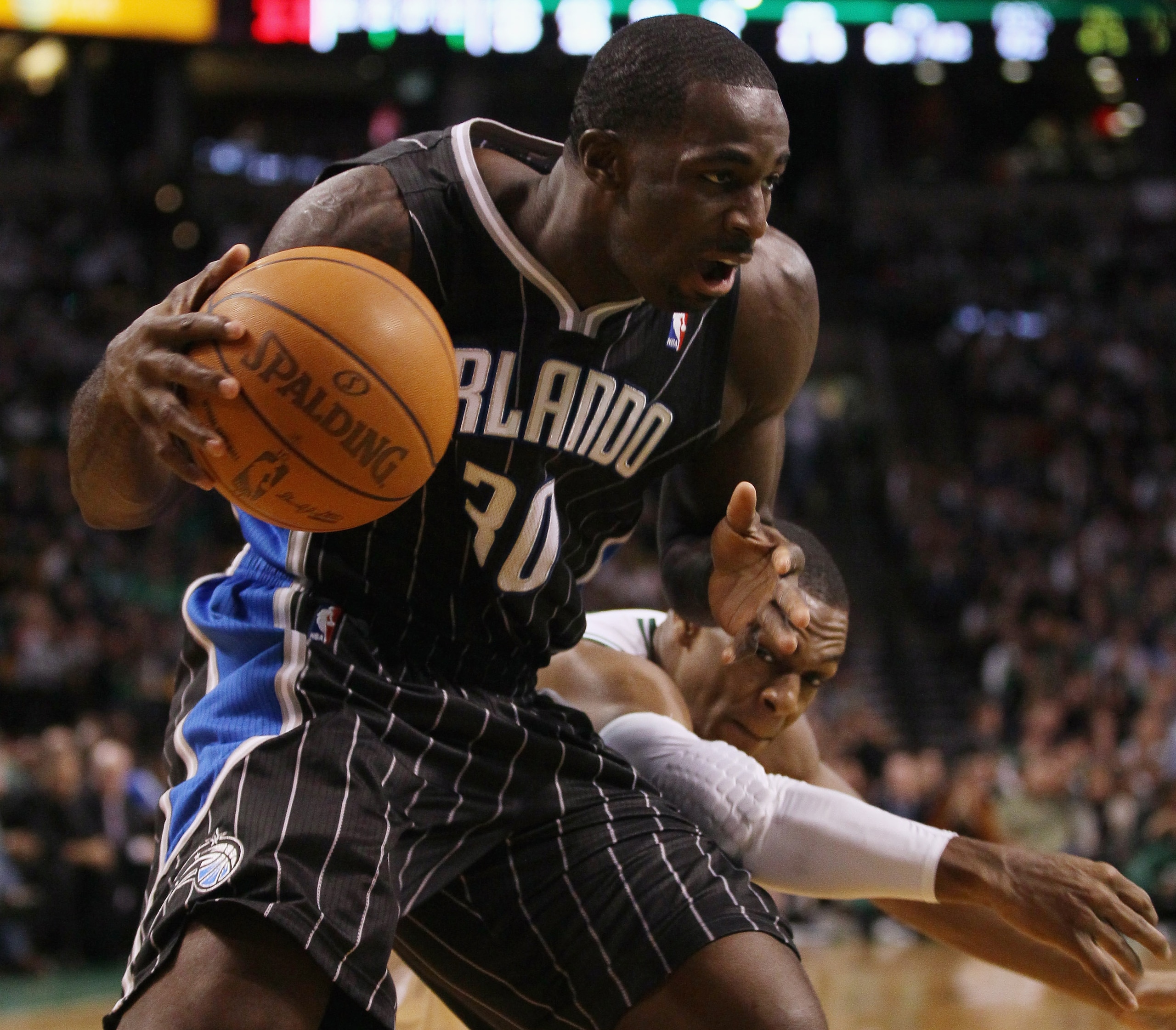 BOSTON, MA - JANUARY 17:   Brandon Bass #30 of the Orlando Magic tries to keep the ball as Rajon Rondo #9 of the Boston Celtics defends on January 17, 2011 at the TD Garden in Boston, Massachusetts. The Celtics defeated the Magic 109-106.  NOTE TO USER: U