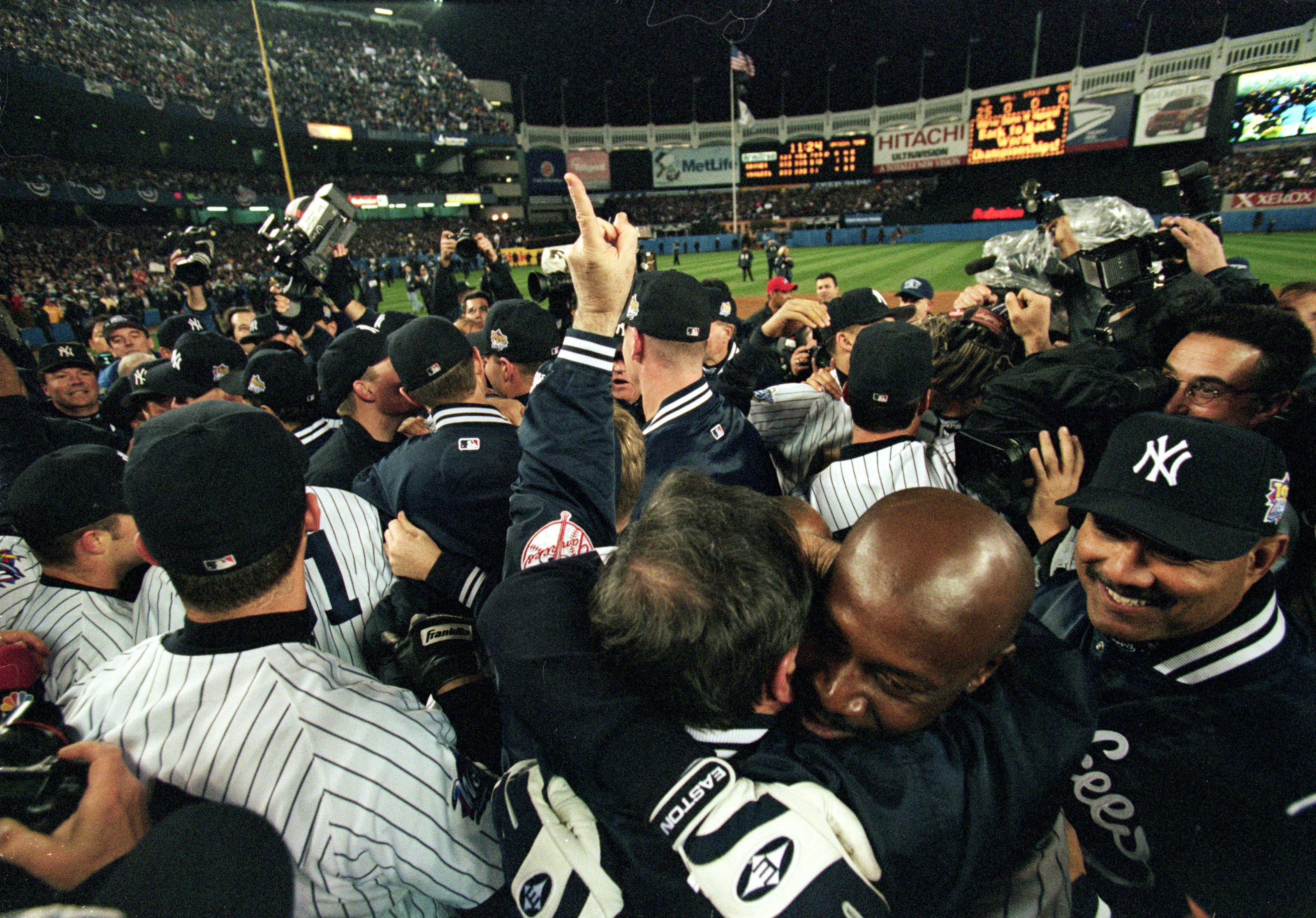 27 Oct 1999: Chille Davis #45 of the New York Yankees hugs the team after winning the World Series Game four against the Atlanta Braves at Yankee Stadium in the Bronx, New York. The Yankees defeated the Braves 4-1.