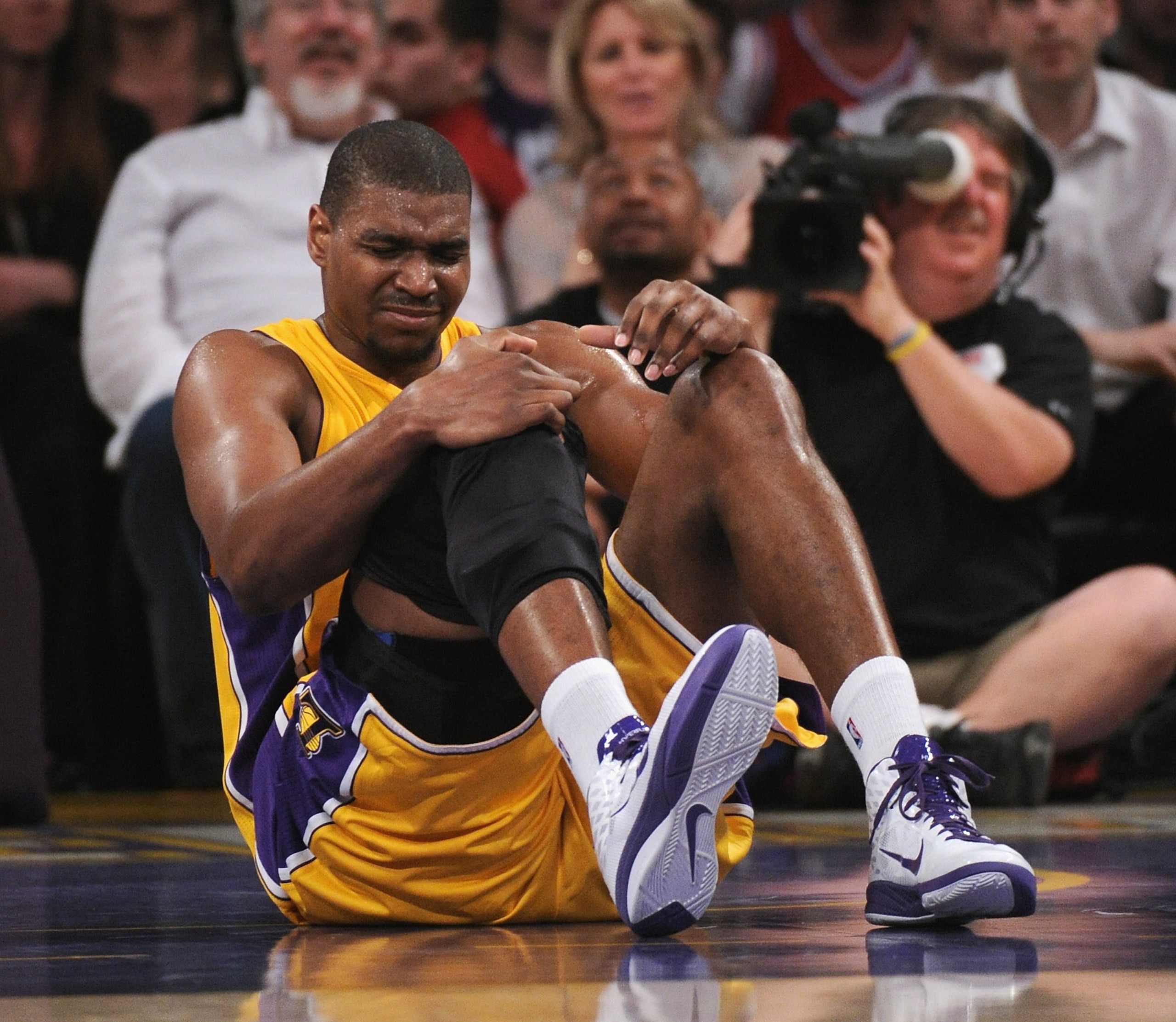 LOS ANGELES, CA - APRIL 12:  Andrew Bynum #17 of the Los Angeles Lakers grimaces after an injury against the San Antonio Spurs at Staples Center on April 12, 2011 in Los Angeles, California.  NOTE TO USER: User expressly acknowledges and agrees that, by d