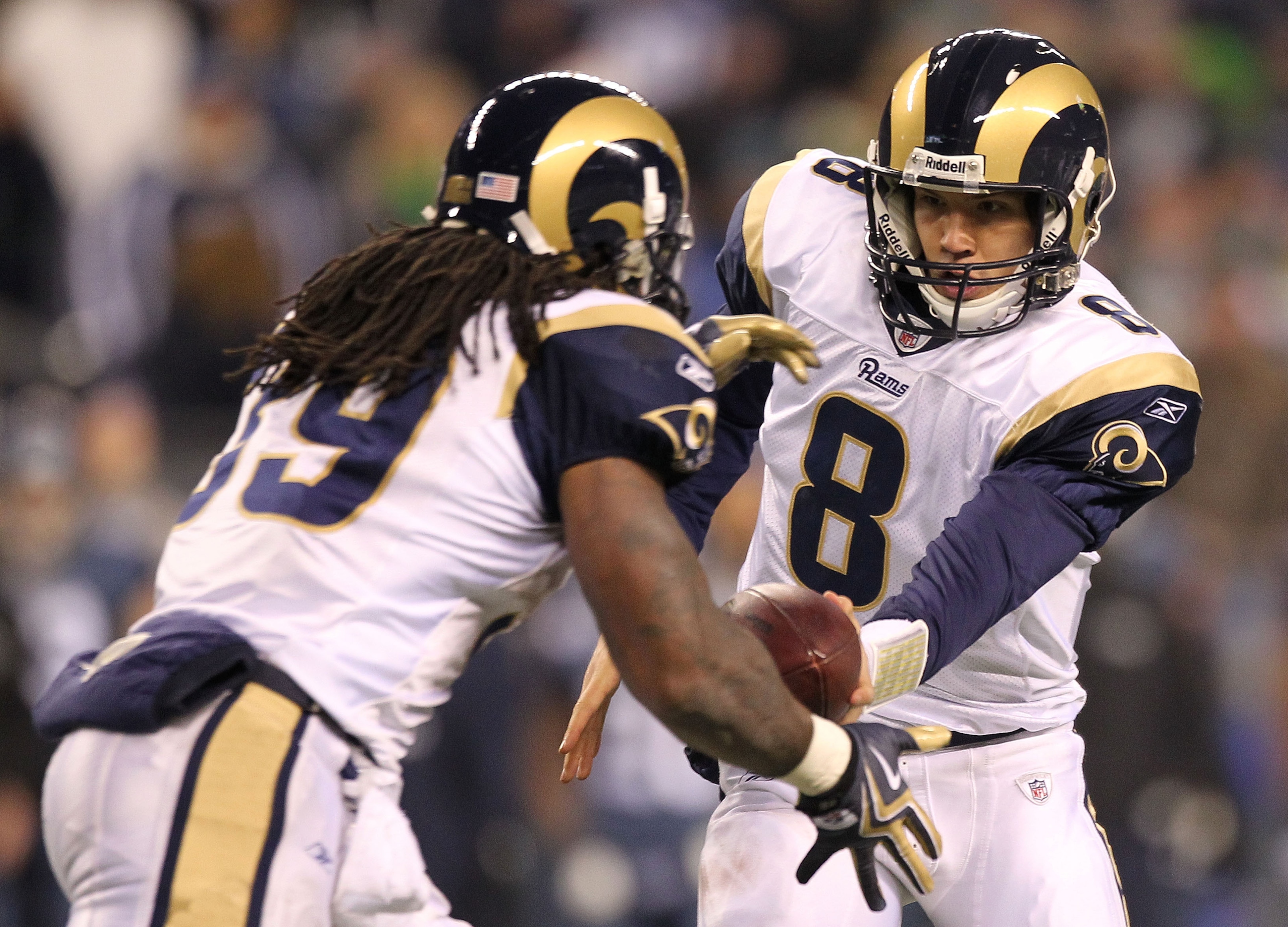 SEATTLE, WA - JANUARY 02:  Quarterback Sam Bradford #8 of the St. Louis Rams hands the ball off to running back Steven Jackson #39 during their game against the Seattle Seahawks at Qwest Field on January 2, 2011 in Seattle, Washington.  (Photo by Otto Gre