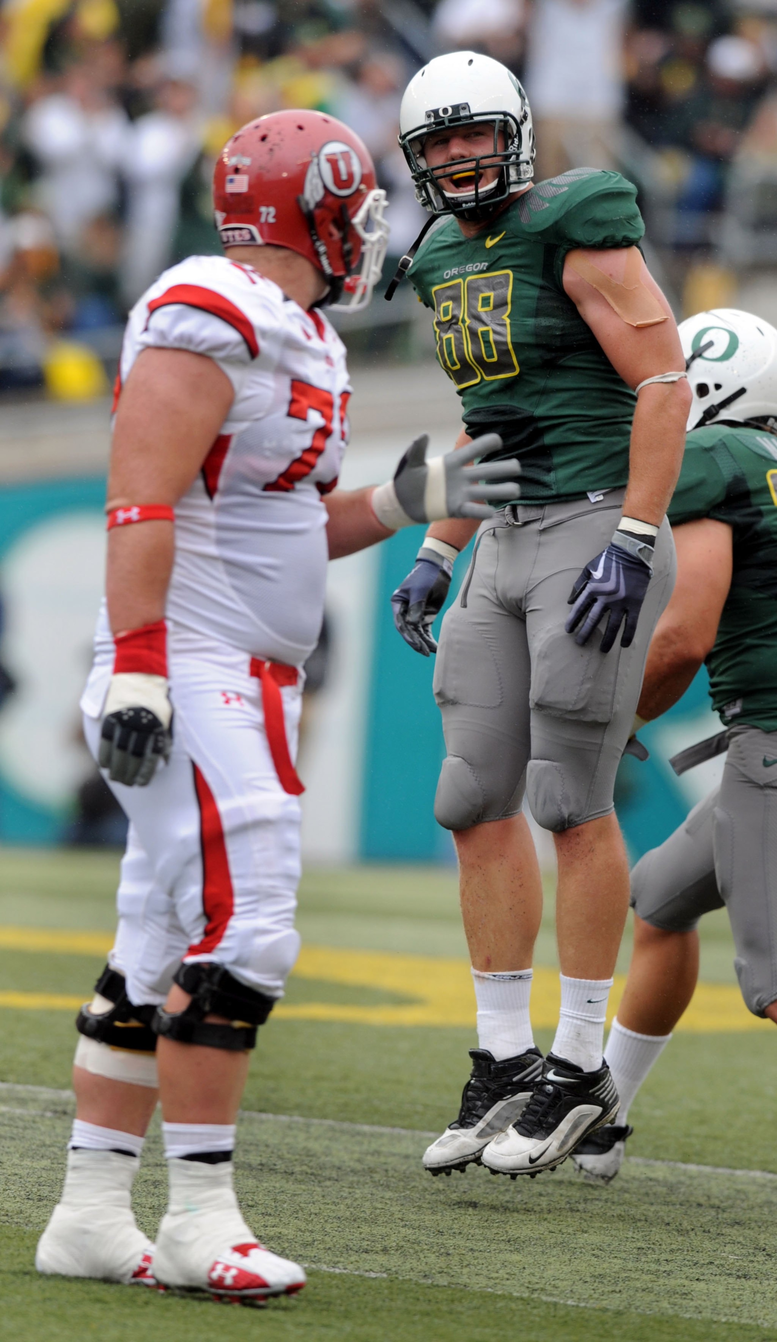 EUGENE, OR - SEPTEMBER 19: Brandon Bair #88 of the Oregon Ducks celebrates after the Ducks recovered a fumble as Caleb Schlauderaff #72 of the Utah Utes walks to the sidelines during the second quarter at Autzen Stadium on September 19, 2009 in Eugene, Or EUGENE, OR - SEPTEMBER 19: Brandon Bair #88 of the Oregon Ducks celebrates after the Ducks recovered a fumble as Caleb Schlauderaff #72 of the Utah Utes walks to the sidelines during the second quarter at Autzen Stadium on September 19, 2009 in Eugene, Or