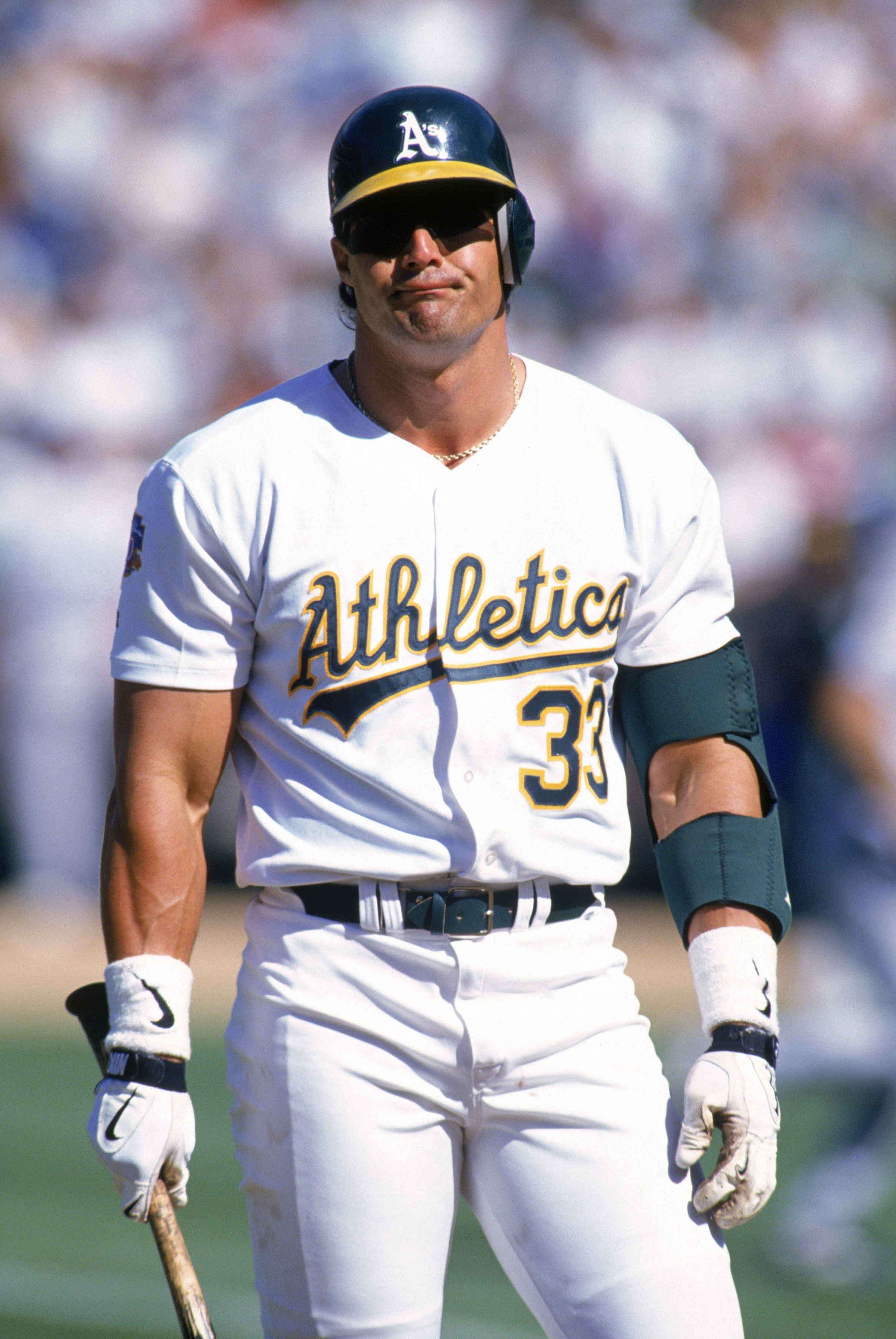 OAKLAND, CA - APRIL 26:  Jose Canseco #33 of the Oakland Athletics reacts during his at bat against the Kansas City Royals at Oakland-Alameda County Coliseum on April 26, 1997 in Oakland, California.  The Athletics won 7-6.  (Photo by Otto Greule Jr/Getty
