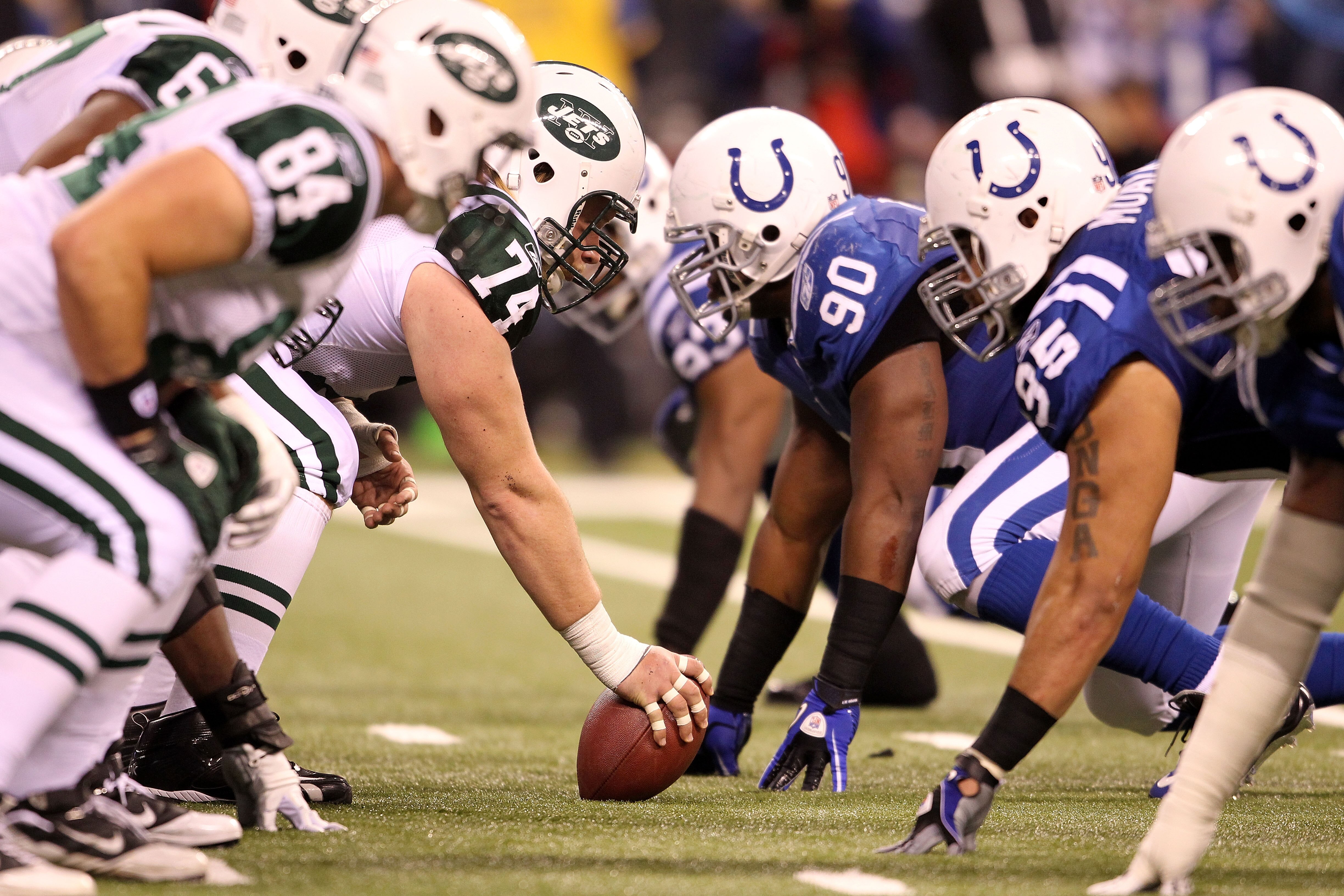 INDIANAPOLIS, IN - JANUARY 08:  Center Nick Mangold #74 of the New York Jets readies the ball for the snap against Dan Muir #90 of the Indianapolis Colts during their 2011 AFC wild card playoff game at Lucas Oil Stadium on January 8, 2011 in Indianapolis,