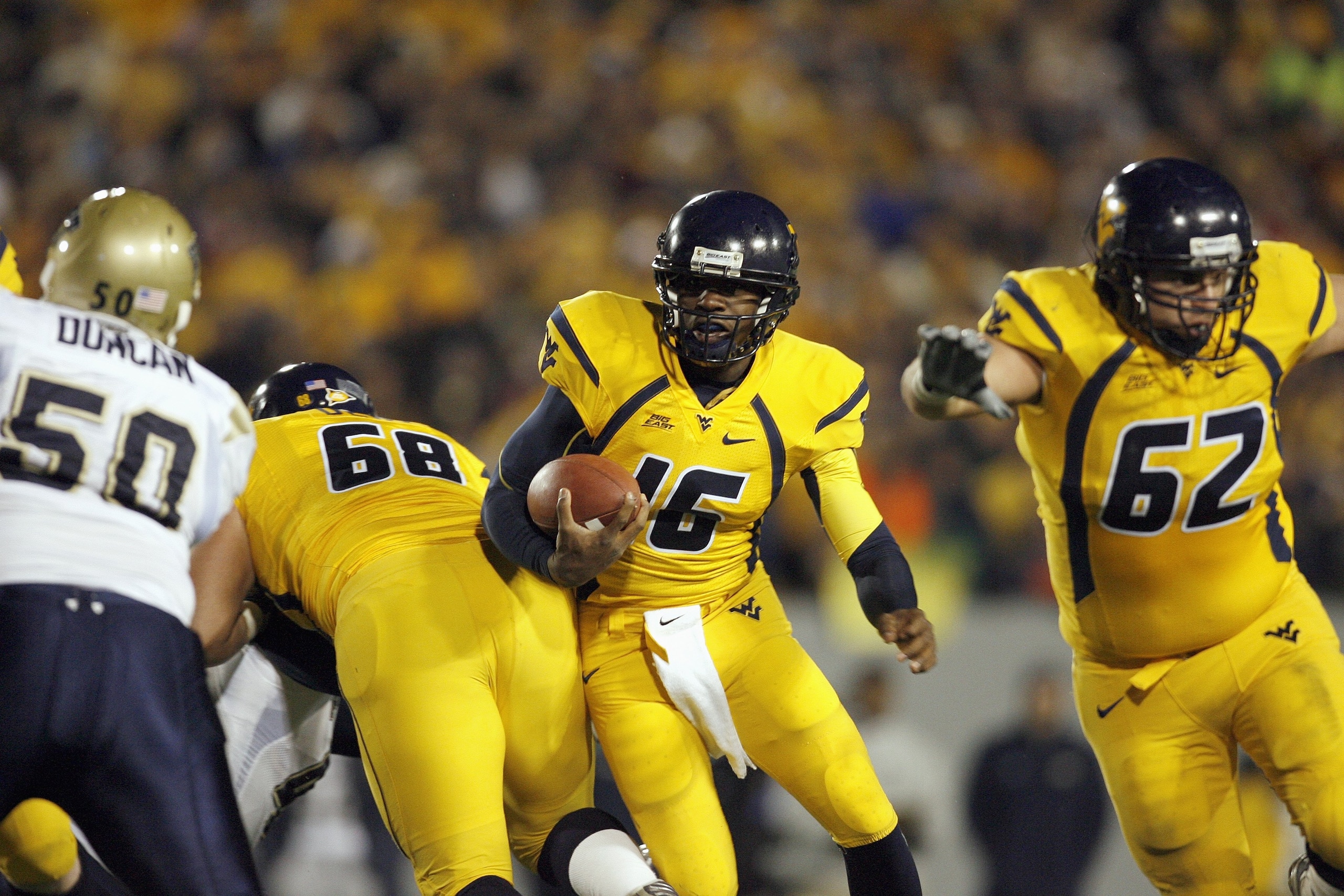 MORGANTOWN, WV - DECEMBER 1: Jarrett Brown #16 of the West Virginia Mountaineers carries the ball during the game against the Pittsburgh Panthers at Milan Puskar Stadium on December 1, 2007 in Morgantown, West Virginia. (Photo by Kevin C. Cox/Getty Images MORGANTOWN, WV - DECEMBER 1: Jarrett Brown #16 of the West Virginia Mountaineers carries the ball during the game against the Pittsburgh Panthers at Milan Puskar Stadium on December 1, 2007 in Morgantown, West Virginia. (Photo by Kevin C. Cox/Getty Images