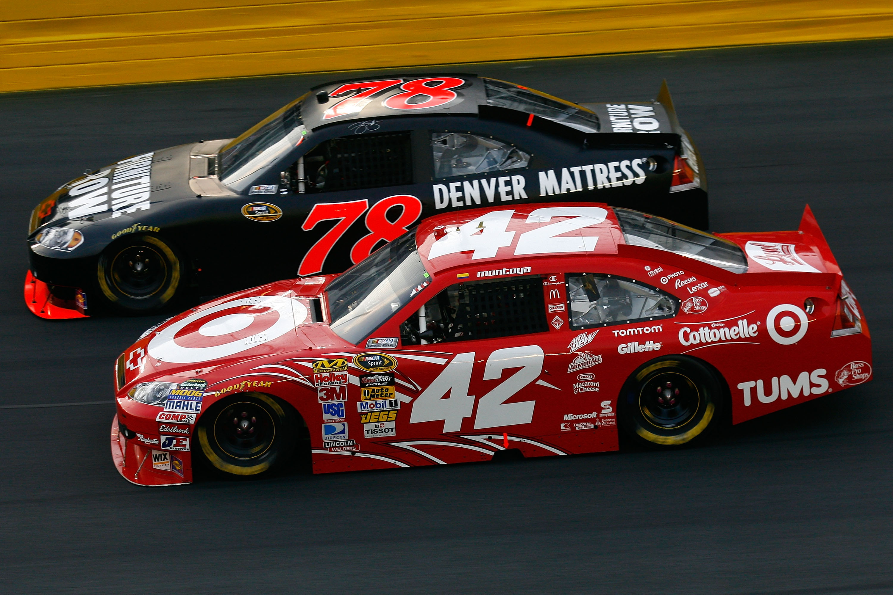 CONCORD, NC - MAY 22:  Juan Pablo Montoya, driver of the #42 Target Chevrolet, and Regan Smith, driver of the #78 Furniture Row Racing Chevrolet, race side by side during the NASCAR Sprint Showdown at Charlotte Motor Speedway on May 22, 2010 in Concord, N