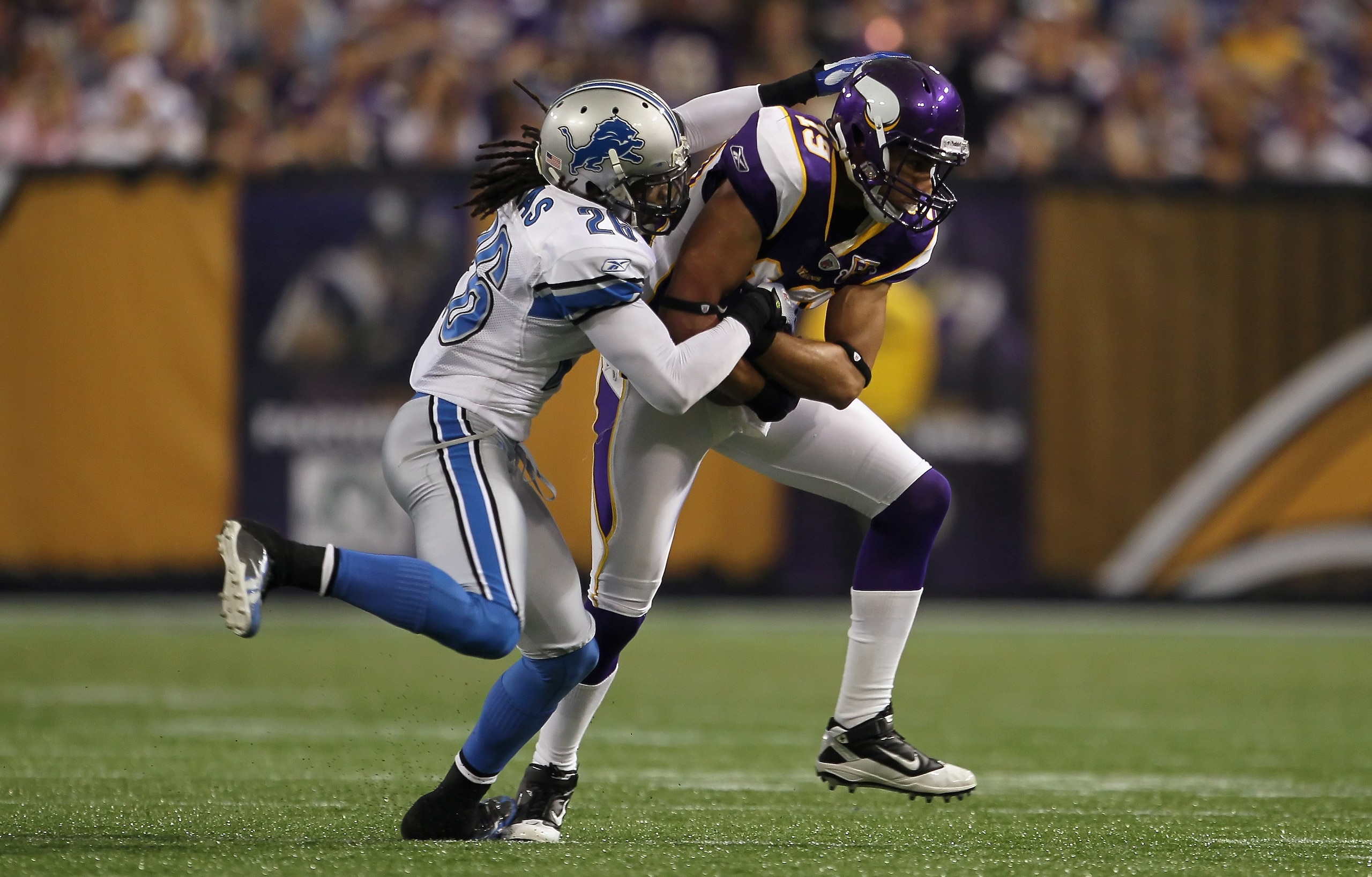 MINNEAPOLIS - SEPTEMBER 26:  Wide receiver Hank Baskett #19 of the Minnesota Vikings is brought down by Louis Delmas #26 of the Detroit Lions at Mall of America Field on September 26, 2010 in Minneapolis, Minnesota. The Vikings defeated the Lions 24-10.  