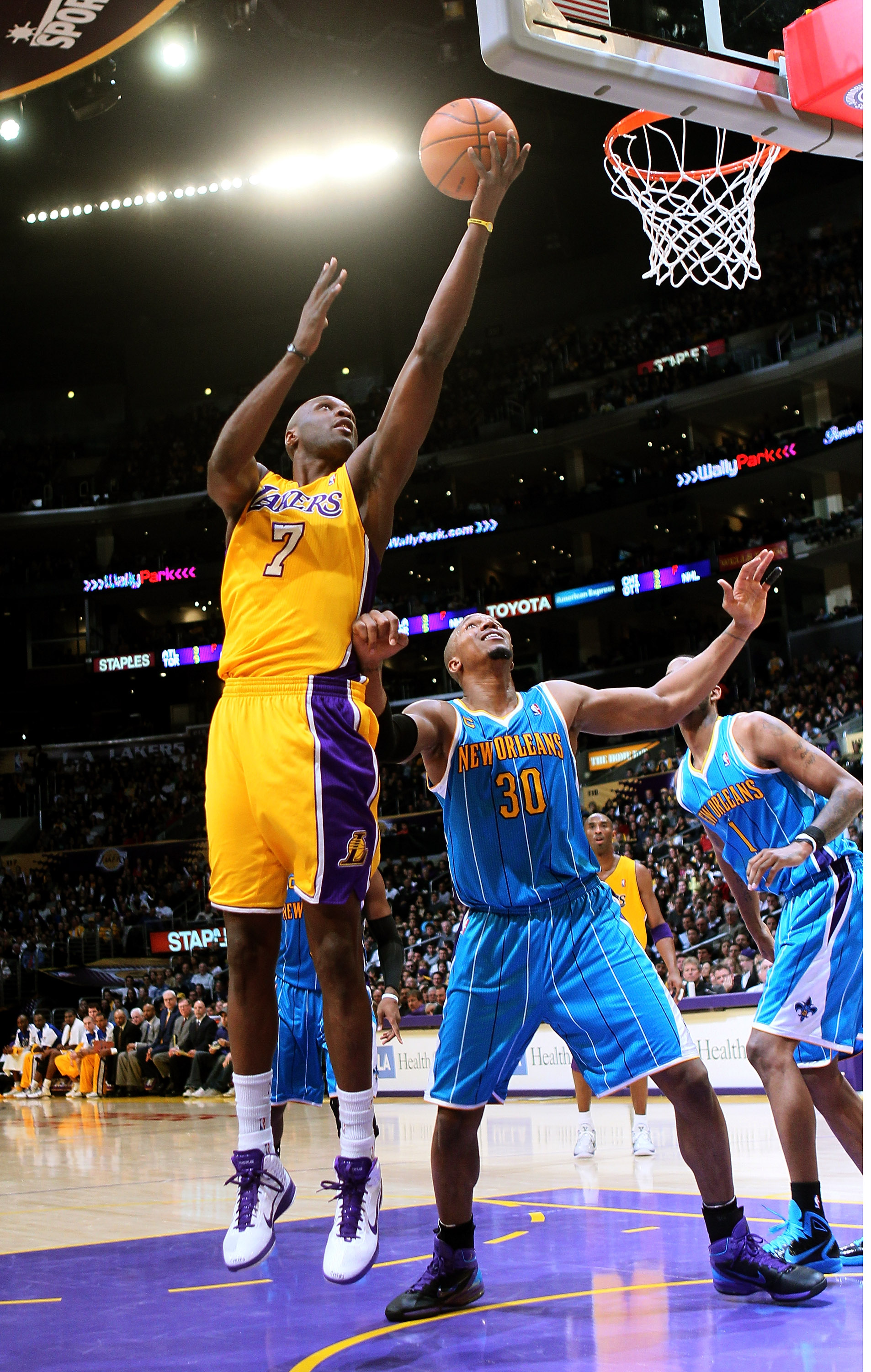 LOS ANGELES, CA - JANUARY 7:  Lamar Odom #7 of the Los Angeles Lakers shoots over David West #30 of the New Orleans Hornets at Staples Center on January 7, 2011 in Los Angeles, California.  The Lakers won 101-97.  NOTE TO USER: User expressly acknowledges