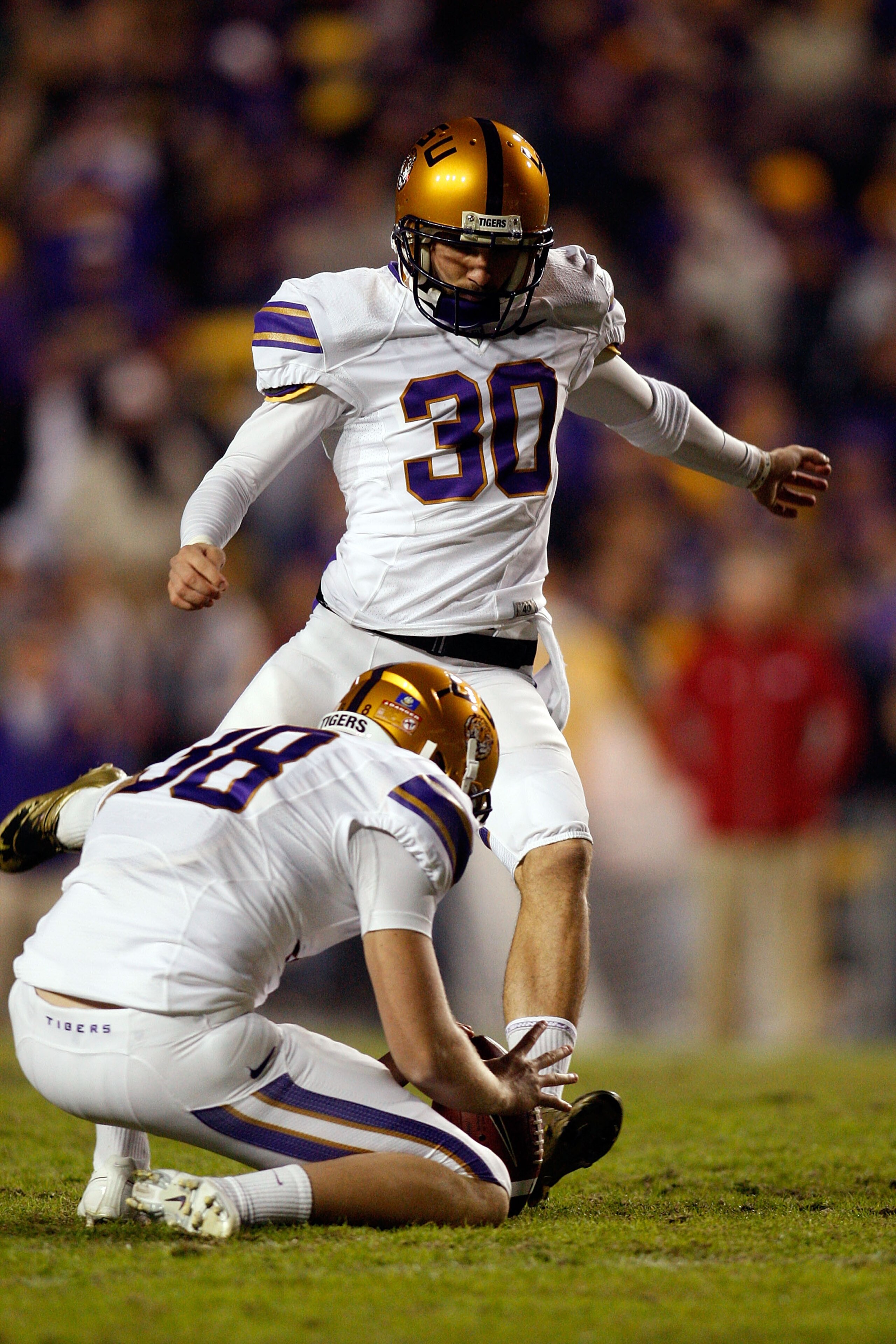 BATON ROUGE, LA - NOVEMBER 28:  Josh Jasper #30 of the LSU Tigers kicks a field goal against the Arkansa Razorbacks at Tiger Stadium on November 28, 2009 in Baton Rouge, Louisiana.  The Tigers defeated the Razorbacks 33-30 in overtime.  (Photo by Chris Gr