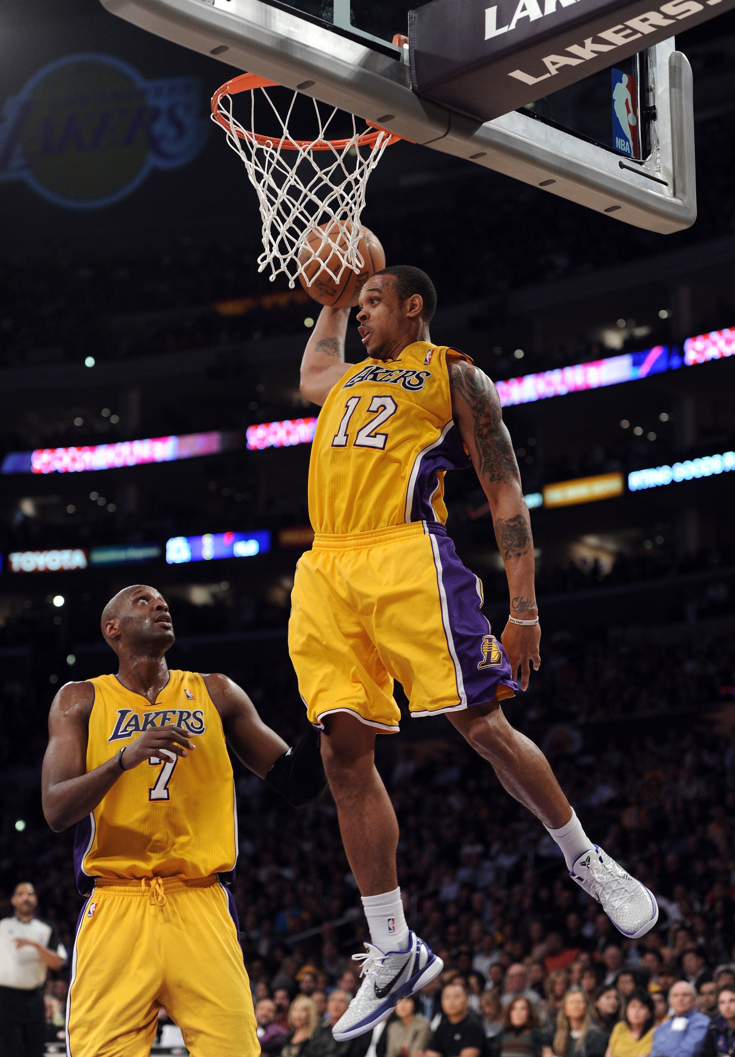 LOS ANGELES, CA - APRIL 12:  Shannon Brown #12 of the Los Angeles Lakers grabs a rebound in front of Lamar Odom #7 against the San Antonio Spurs during the game at Staples Center on April 12, 2011 in Los Angeles, California.  NOTE TO USER: User expressly