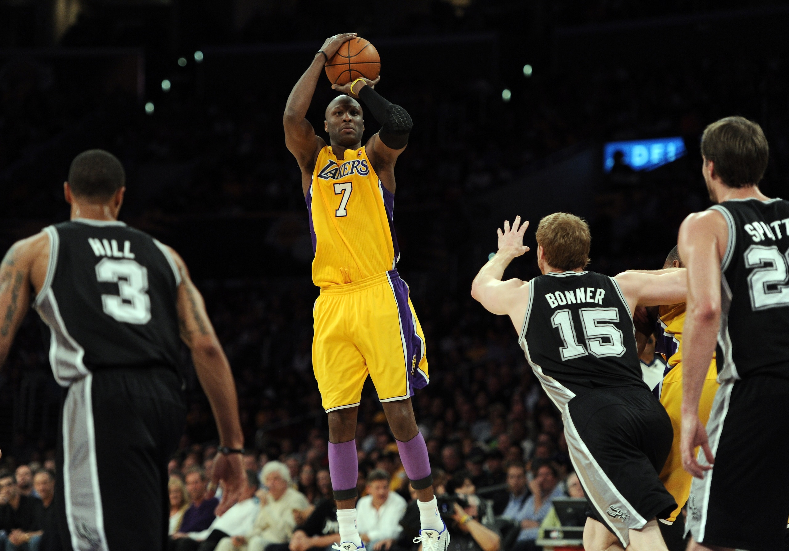 LOS ANGELES, CA - APRIL 12:  Lamar Odom #7 of the Los Angeles Lakers shoots a jumper in front of Matt Bonner #15, George Hill #3 and Tiago Splitter #22 of the San Antonio Spurs during the game at Staples Center on April 12, 2011 in Los Angeles, California