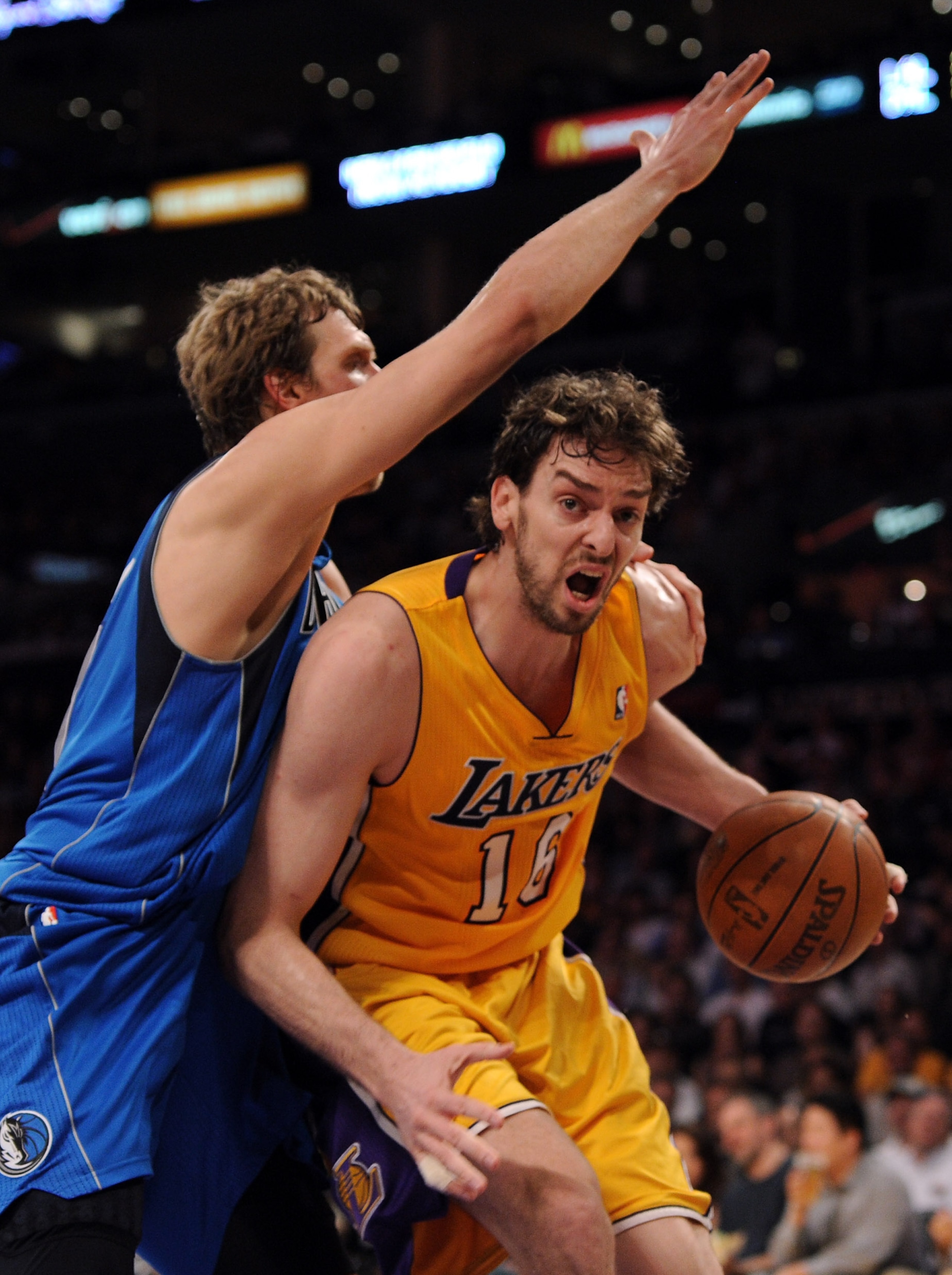 LOS ANGELES, CA - MARCH 31:  Paul Gasol #16 of the Los Angeles Lakers ducks under Dirk Nowitzki #41 of the Dallas Mavericks at Staples Center on March 31, 2011 in Los Angeles, California.  NOTE TO USER: User expressly acknowledges and agrees that, by down