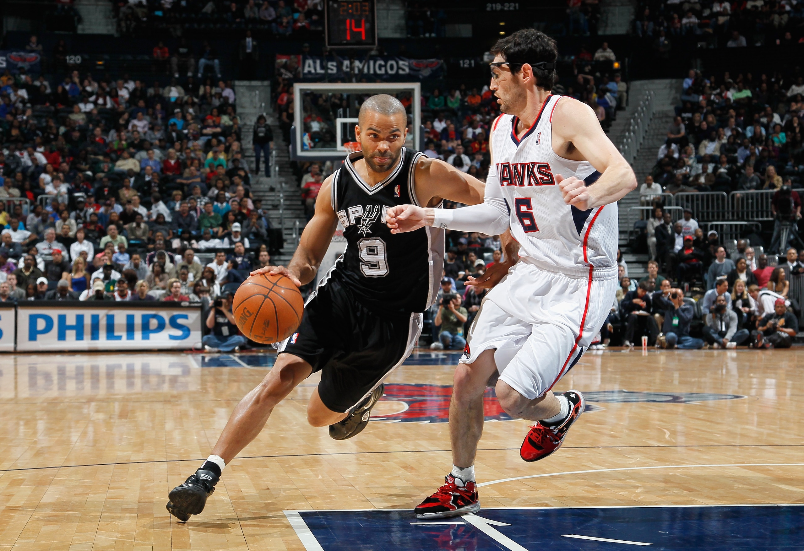 ATLANTA, GA - APRIL 05:  Tony Parker #9 of the San Antonio Spurs against Kirk Hinrich #6 of the Atlanta Hawks at Philips Arena on April 5, 2011 in Atlanta, Georgia.  NOTE TO USER: User expressly acknowledges and agrees that, by downloading and/or using th