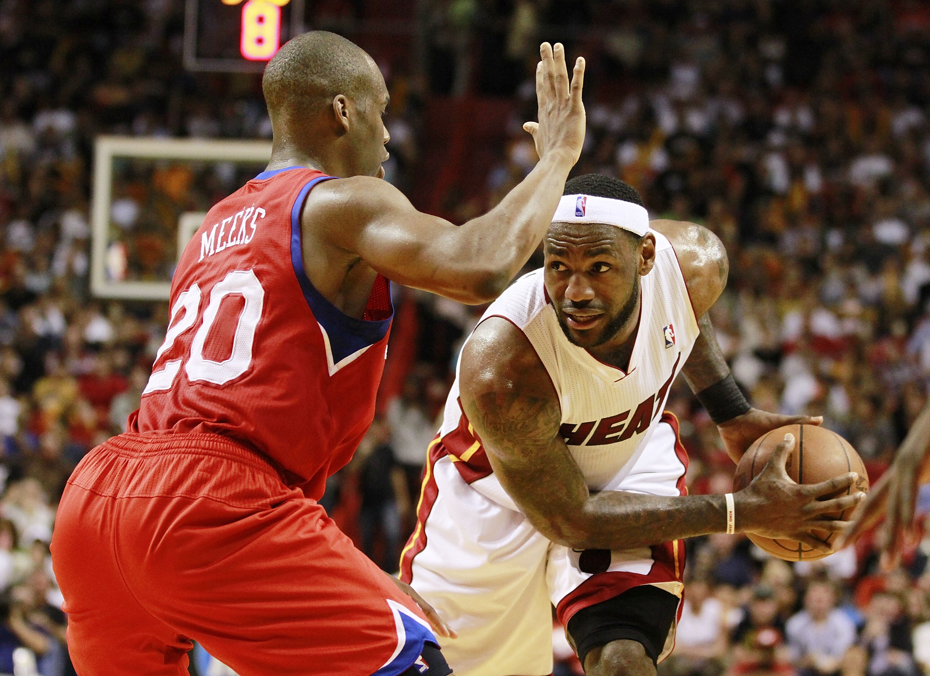 MIAMI, FL - MARCH 25:  Forward LeBron James #6  of the Miami Heat drives against Guard Jodie Meeks #20 of the Philadelphia 76ers at American Airlines Arena on March 25, 2011 in Miami, Florida. The Heat defeated the Sixers 111-99. NOTE TO USER: User expres