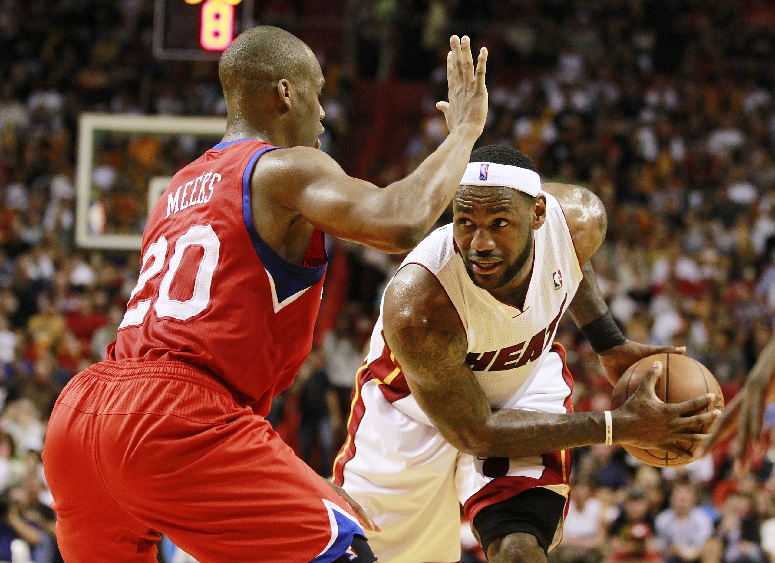 MIAMI, FL - MARCH 25:  Forward LeBron James #6  of the Miami Heat drives against Guard Jodie Meeks #20 of the Philadelphia 76ers at American Airlines Arena on March 25, 2011 in Miami, Florida. The Heat defeated the Sixers 111-99. NOTE TO USER: User expres