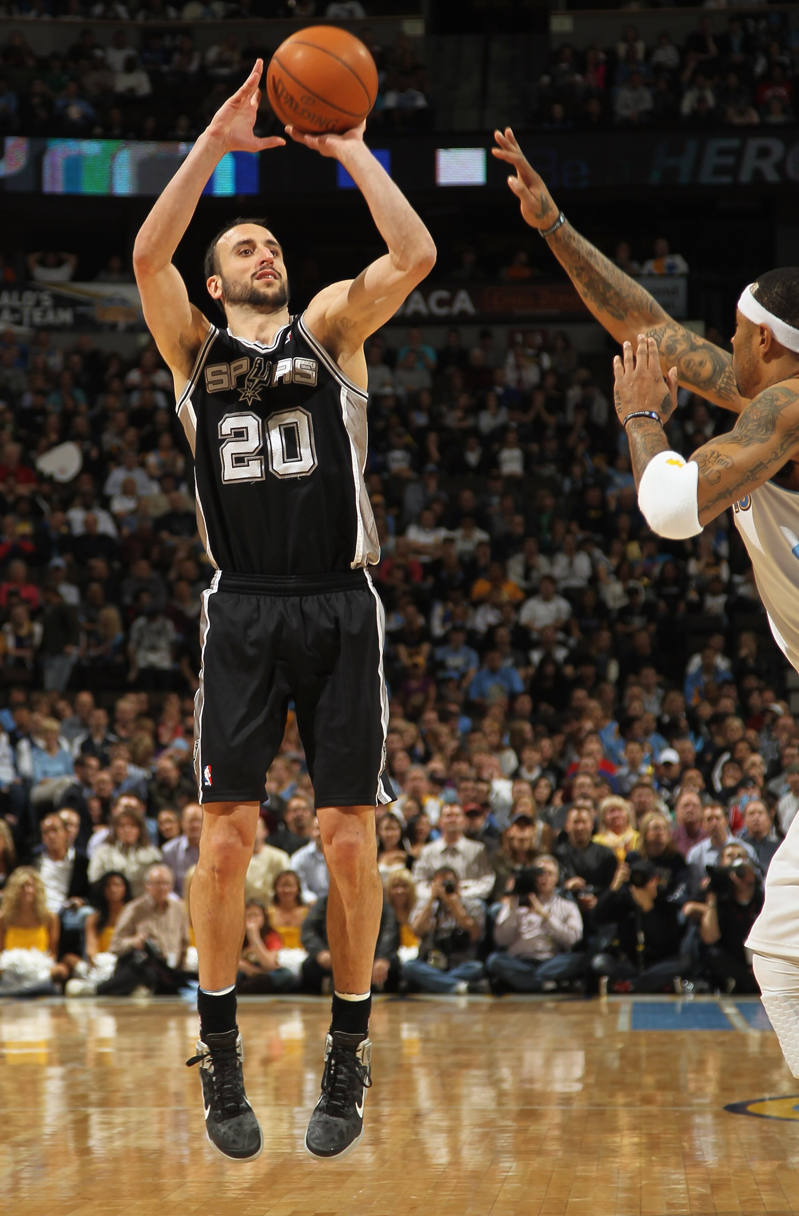 DENVER, CO - MARCH 23:  Manu Ginobili #20 of the San Antonio Spurs takes a shot over Kenyon Martin #4 of the Denver Nuggets at the Pepsi Center on March 23, 2011 in Denver, Colorado. NOTE TO USER: User expressly acknowledges and agrees that, by downloadin
